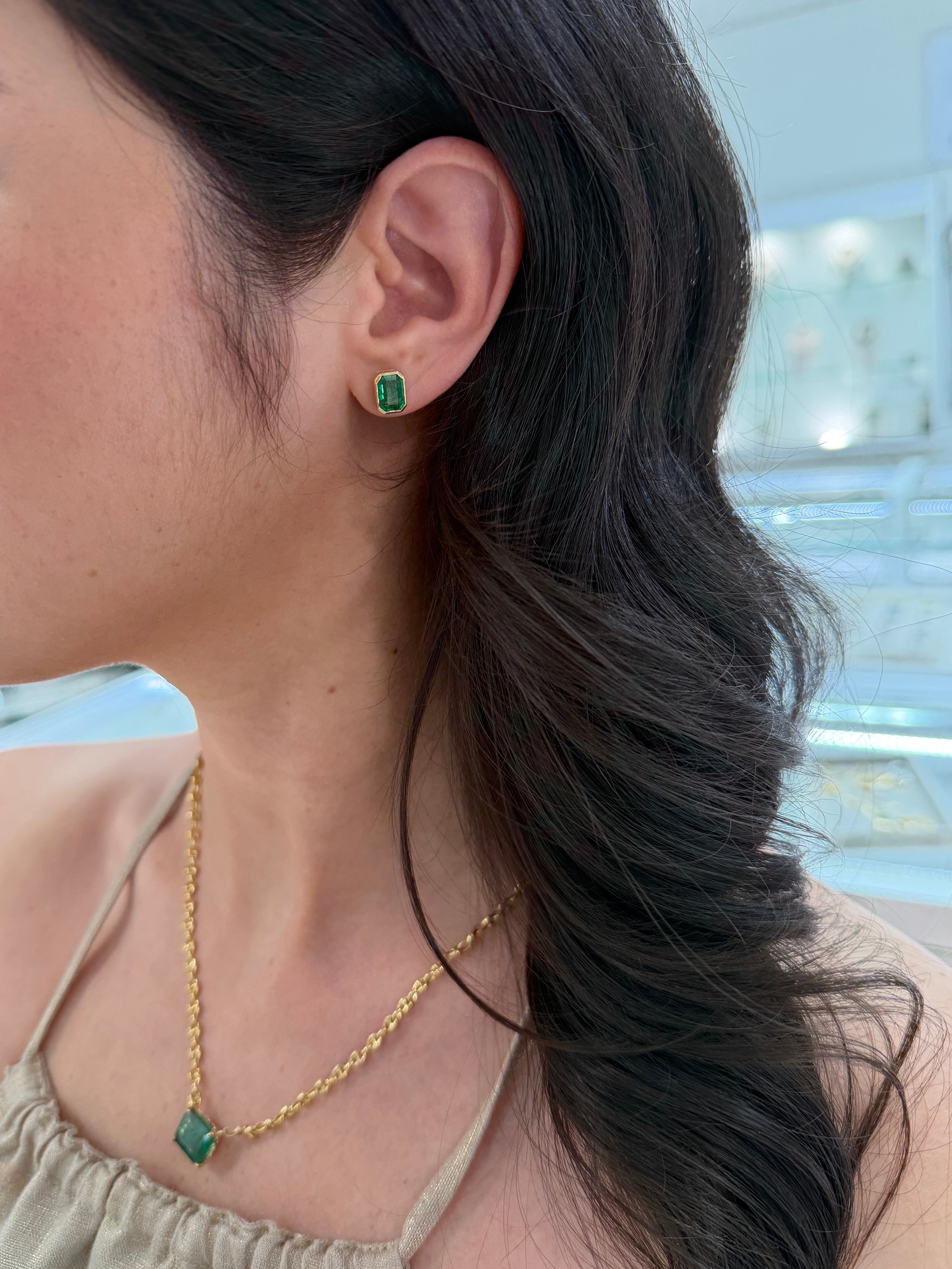 Emerald stud earrings with bezel setting, 3.33 carats total, featuring JR Colombian Emeralds in 18K gold.