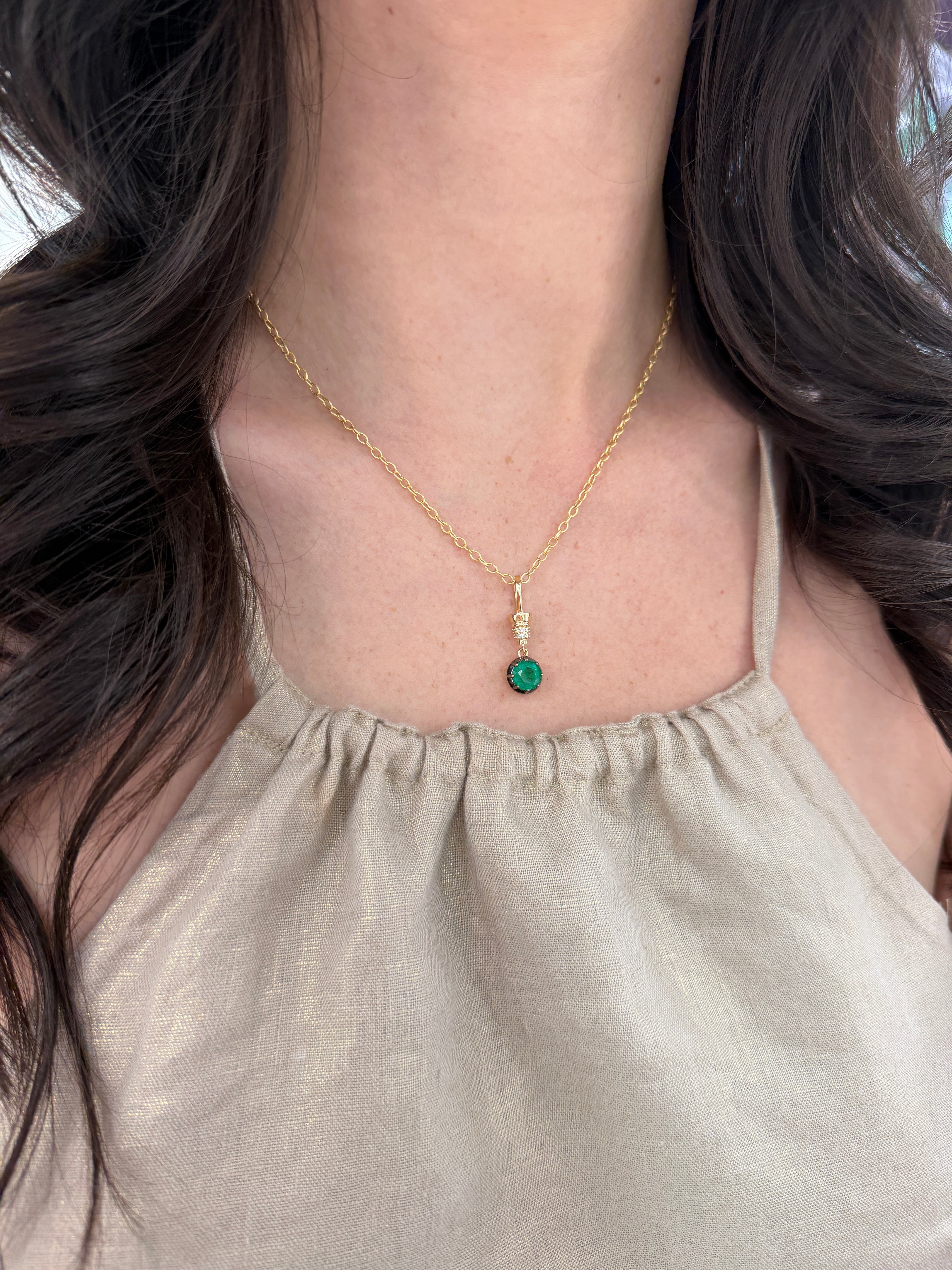 14K gold emerald pendant necklace with round cut emerald and diamond accents, featuring a multi-prong setting from JR Colombian Emeralds.