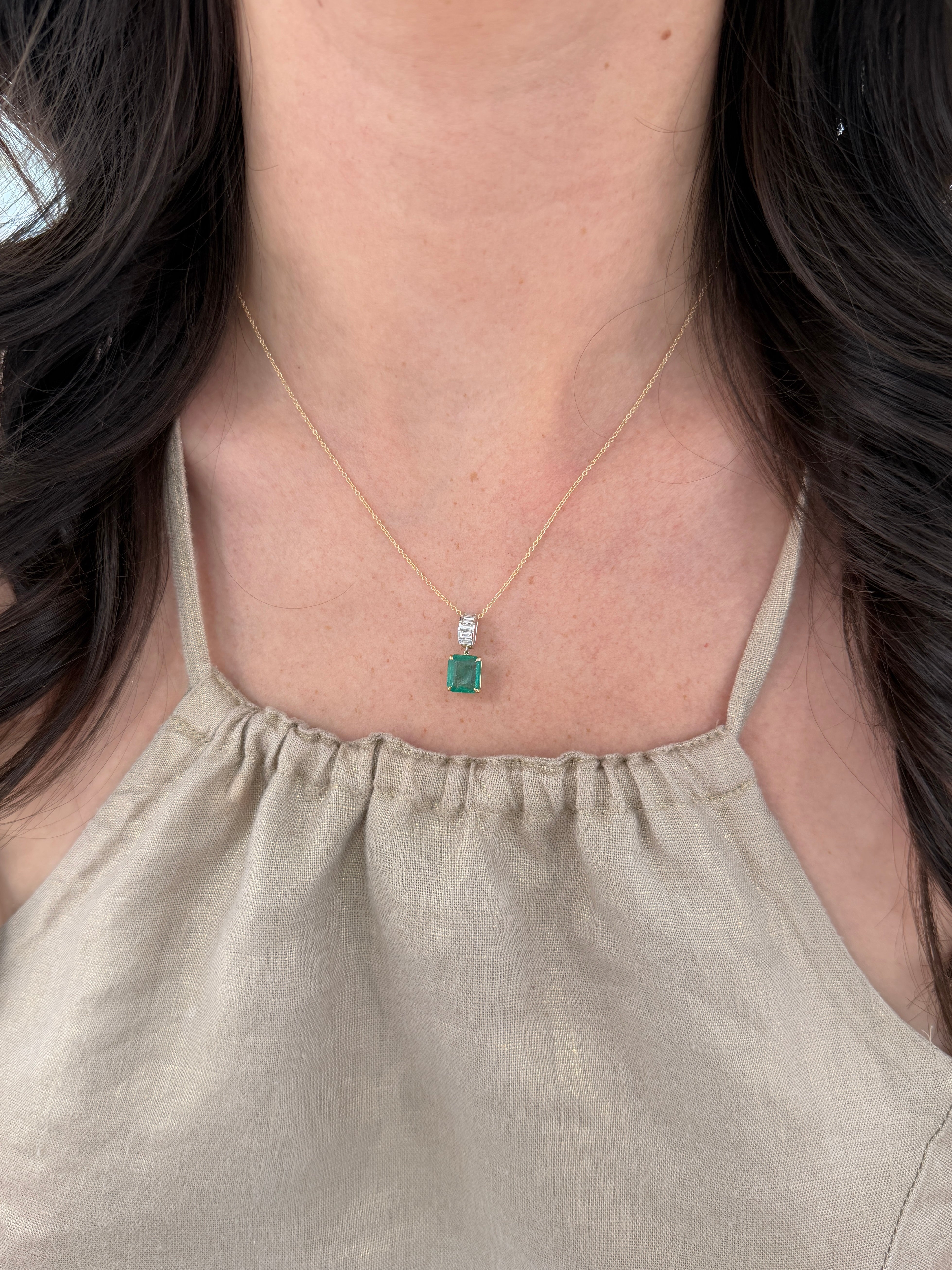 Asscher cut emerald and lab diamond baguette bail pendant in 14K gold, showcasing elegant gemstone settings and craftsmanship.