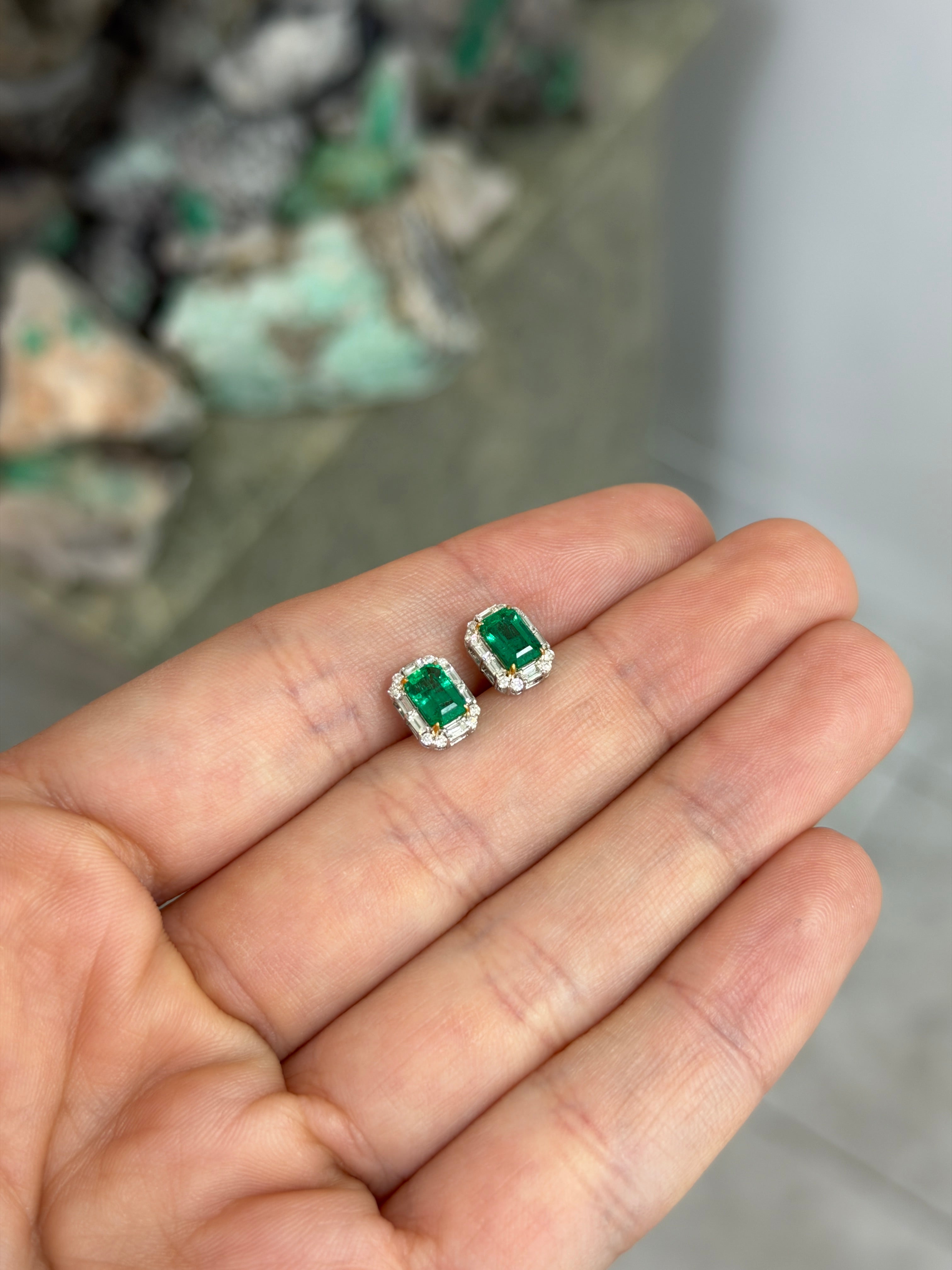 Natural emerald and baguette diamond halo stud earrings in 18K two-tone gold, featuring 1.59 total carats from JR Colombian Emeralds.