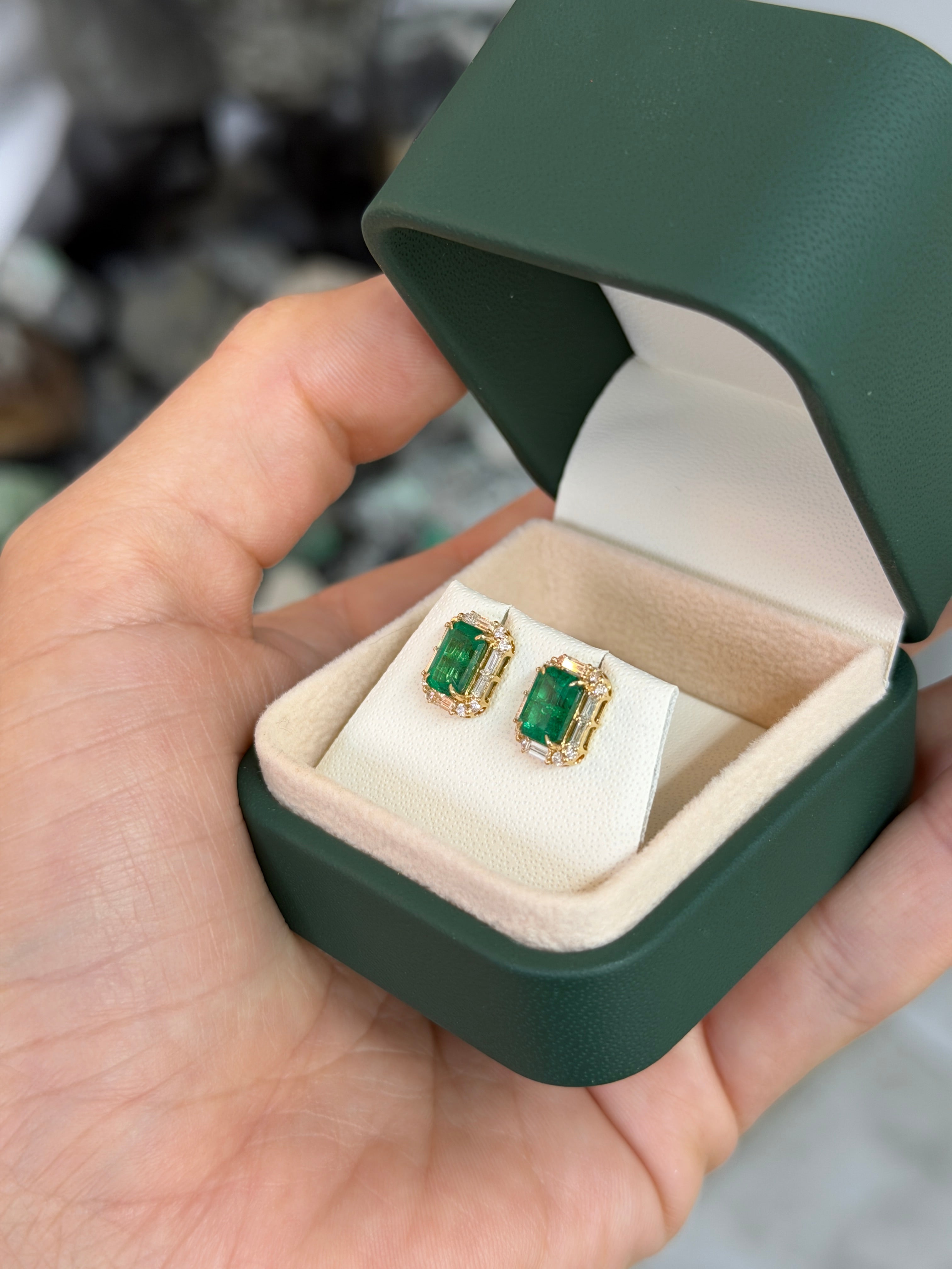 18K gold stud earrings with rich green emeralds and baguette diamond halo, featuring 2.55 carats total weight, by JR Colombian Emeralds.
