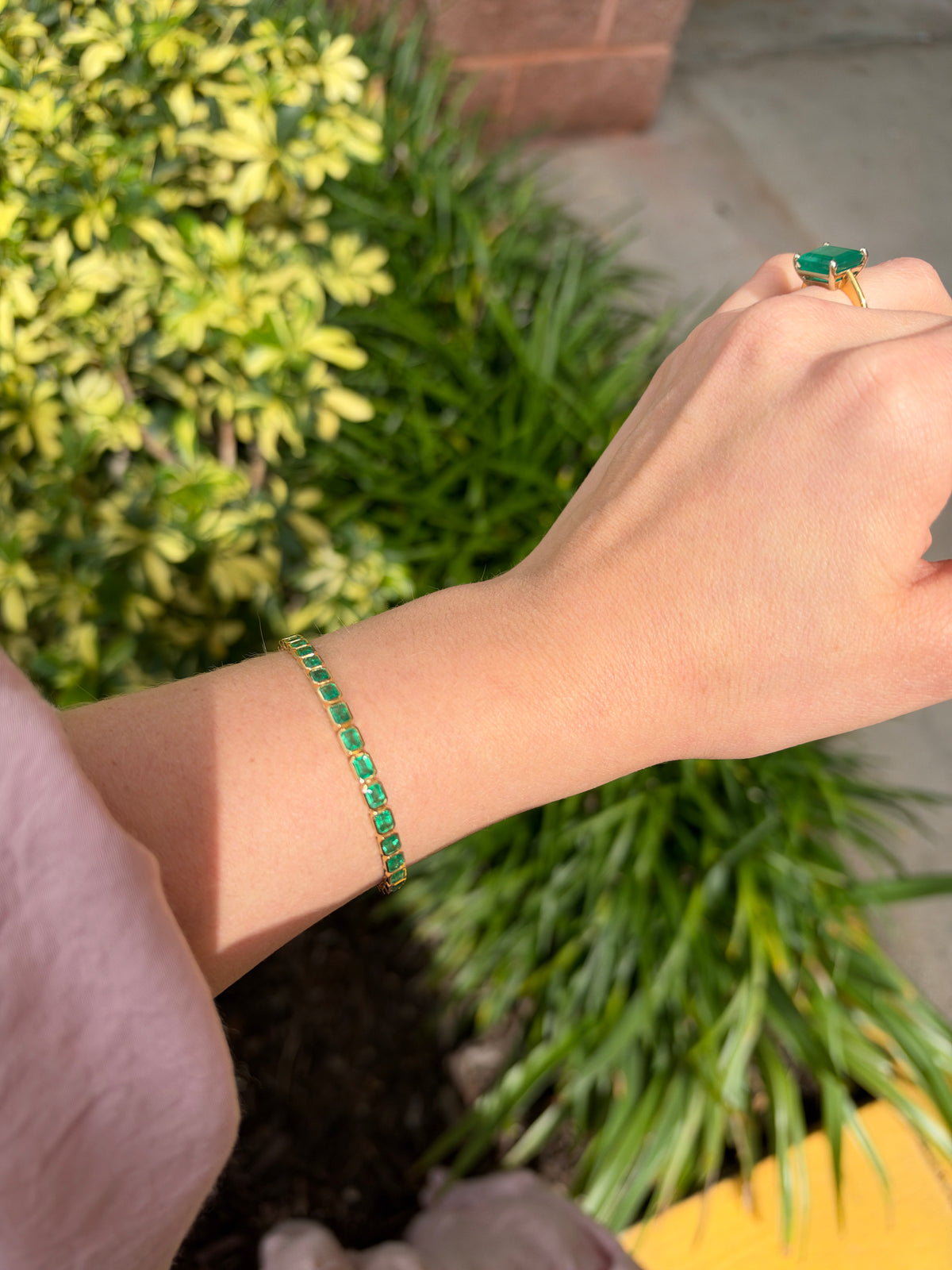 14K gold emerald tennis bracelet with 6.69 carats east-to-west bezel set emeralds by JR Colombian Emeralds.