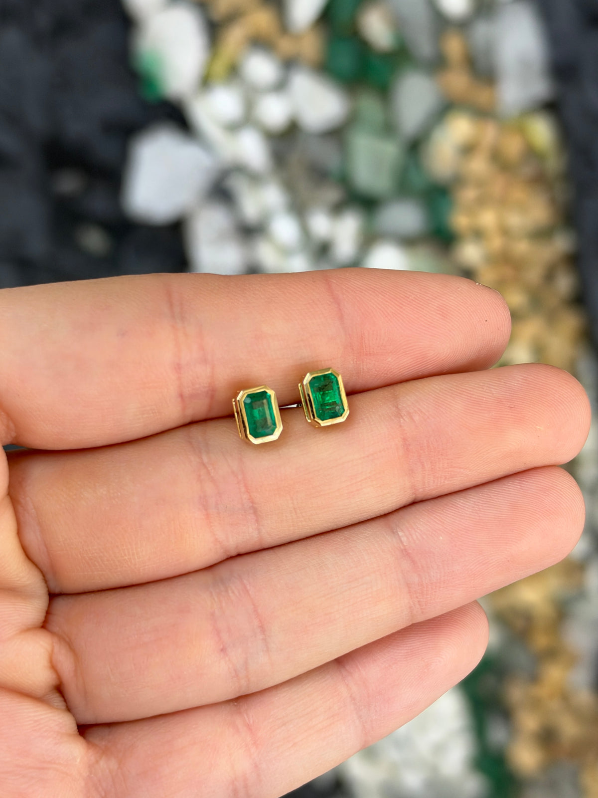 14K natural emerald cut emerald stud earrings with bezel setting, 1.20tcw from JR Colombian Emeralds, close-up view.