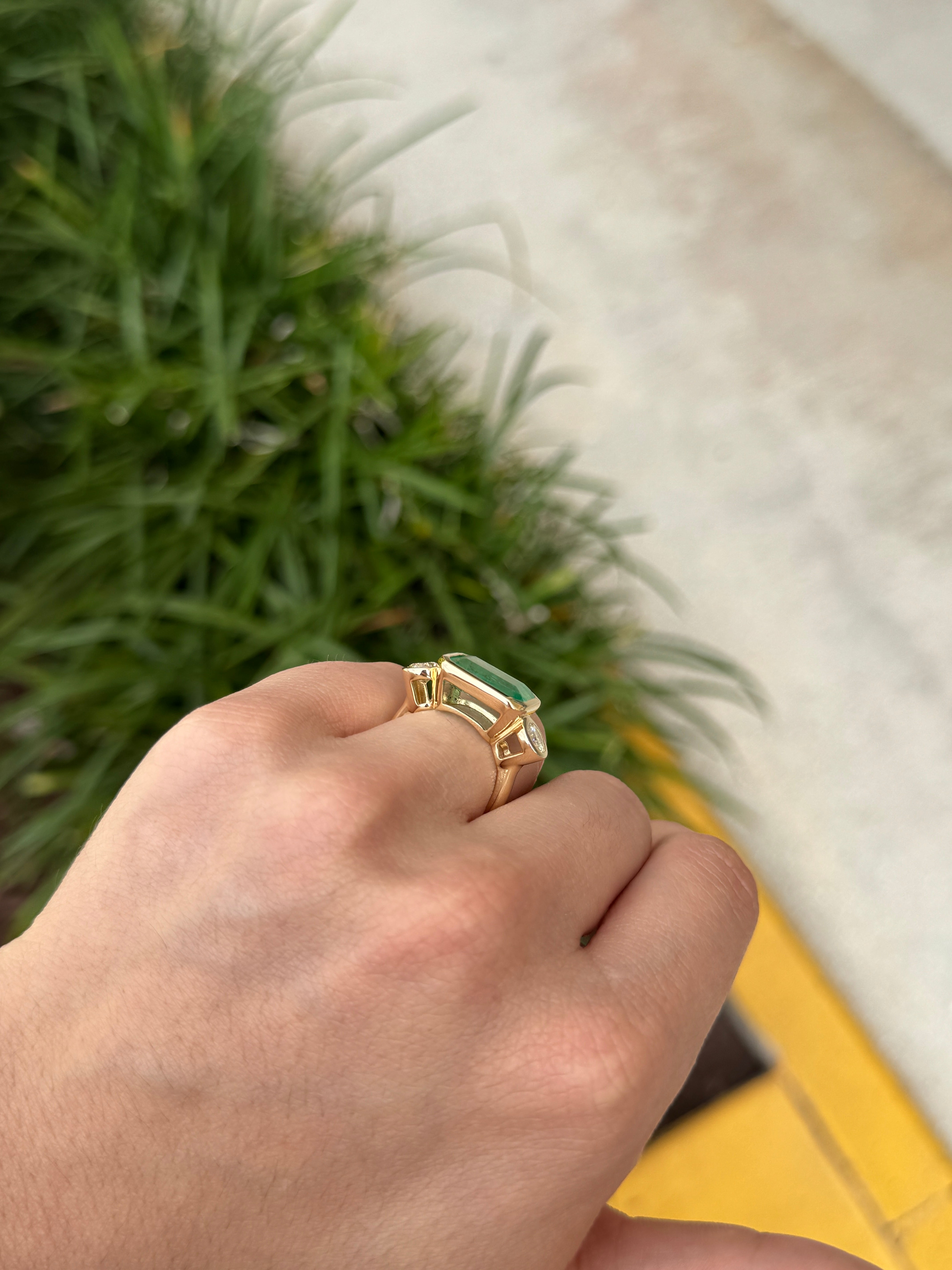 6.30 Carat Colombian Emerald East West Bezel Ring With Round Diamonds In 18K Gold Full Finger Coverage