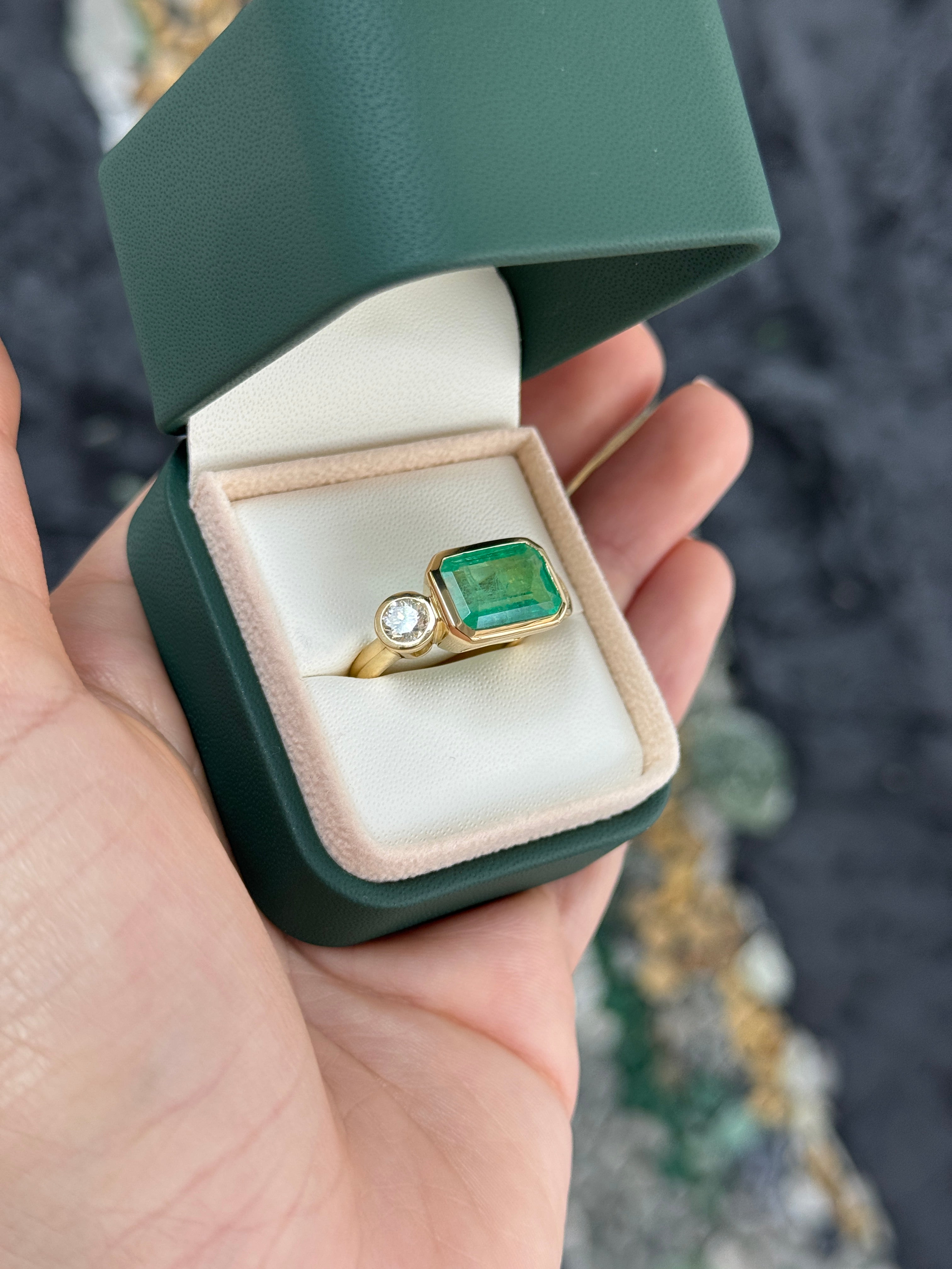 6.30 Carat Colombian Emerald East West Bezel Ring With Round Diamonds In 18K Gold Full Finger Coverage