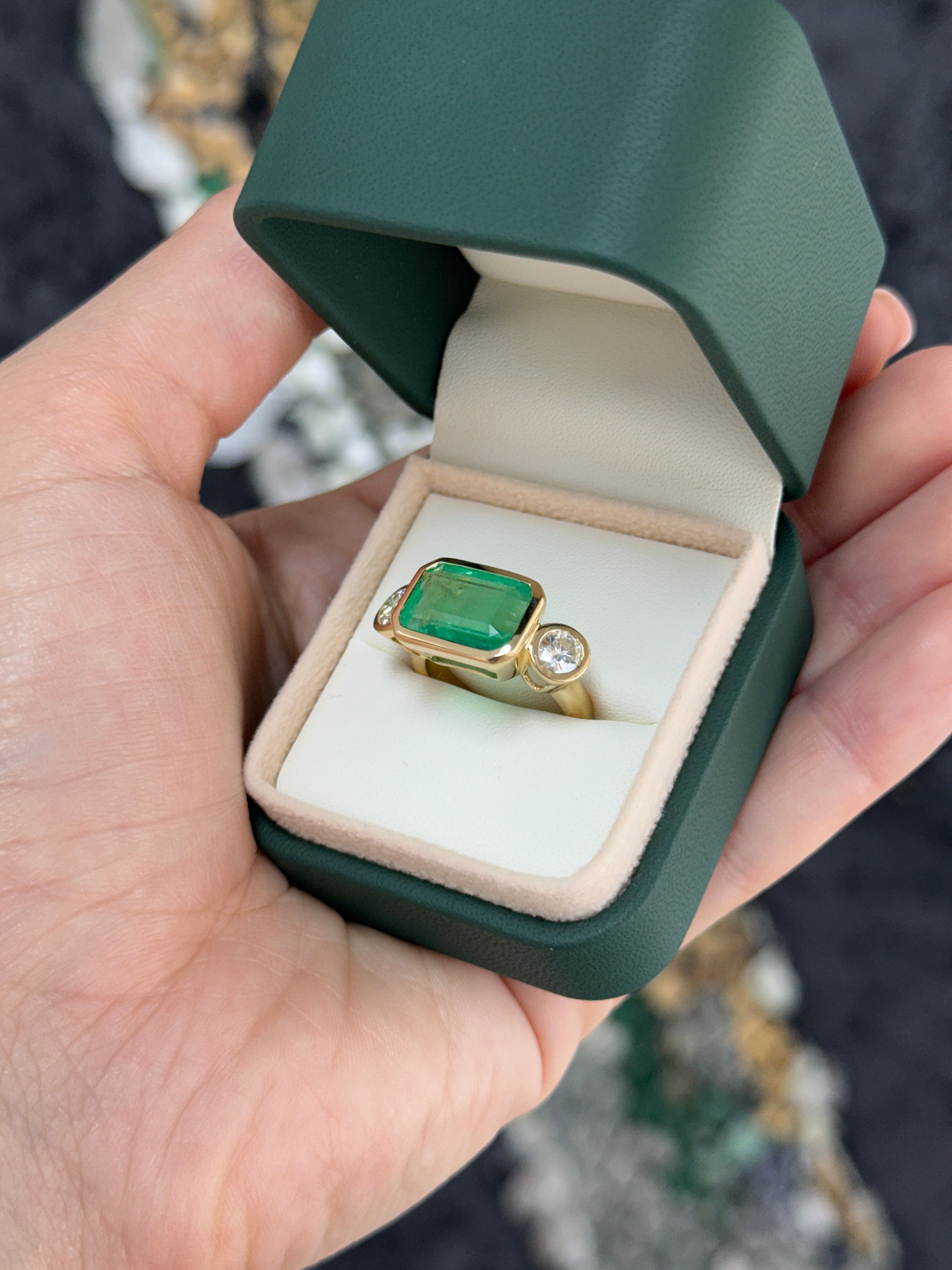 6.30 Carat Colombian Emerald East West Bezel Ring With Round Diamonds In 18K Gold Full Finger Coverage