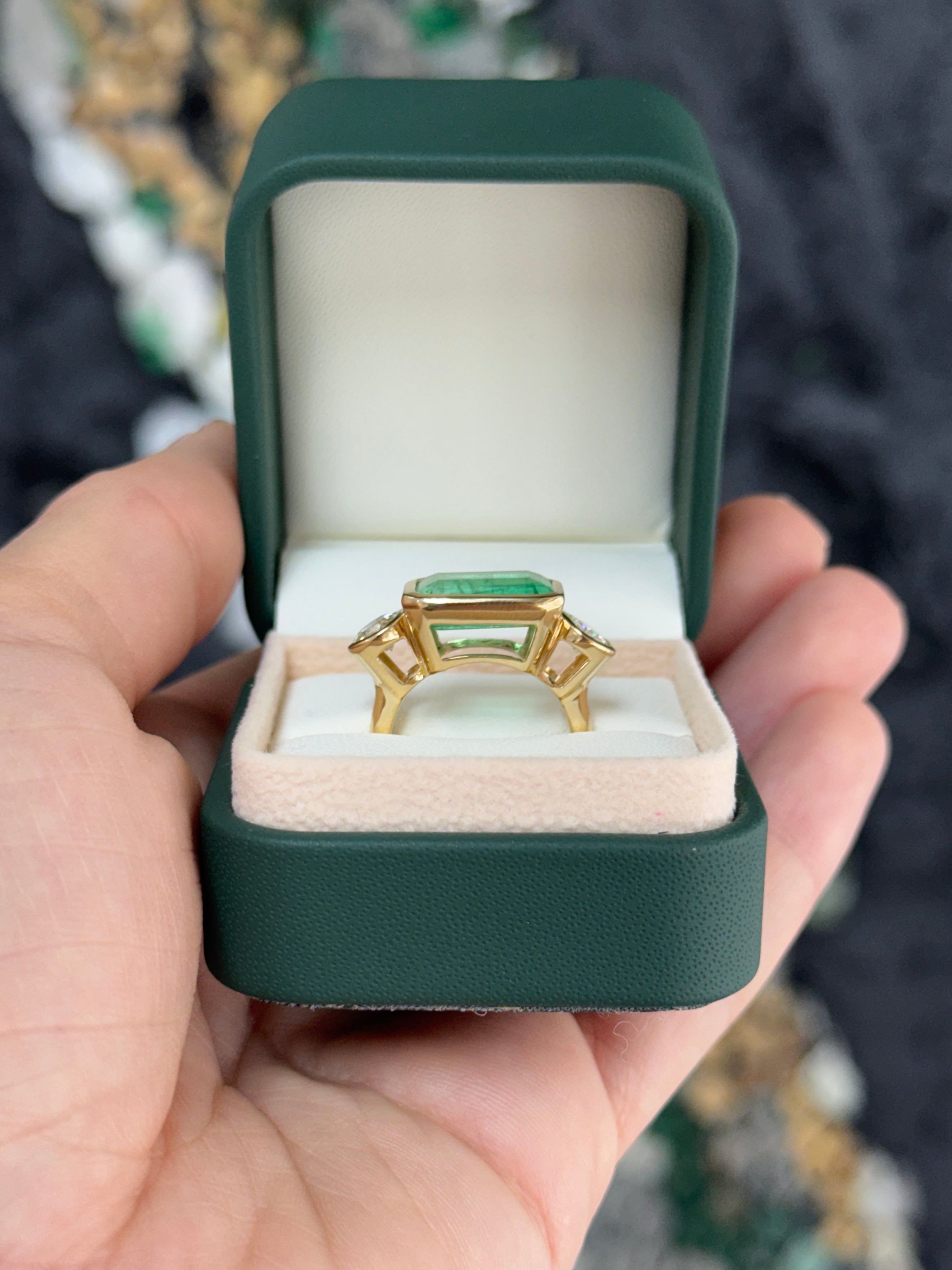 6.30 Carat Colombian Emerald East West Bezel Ring With Round Diamonds In 18K Gold Full Finger Coverage