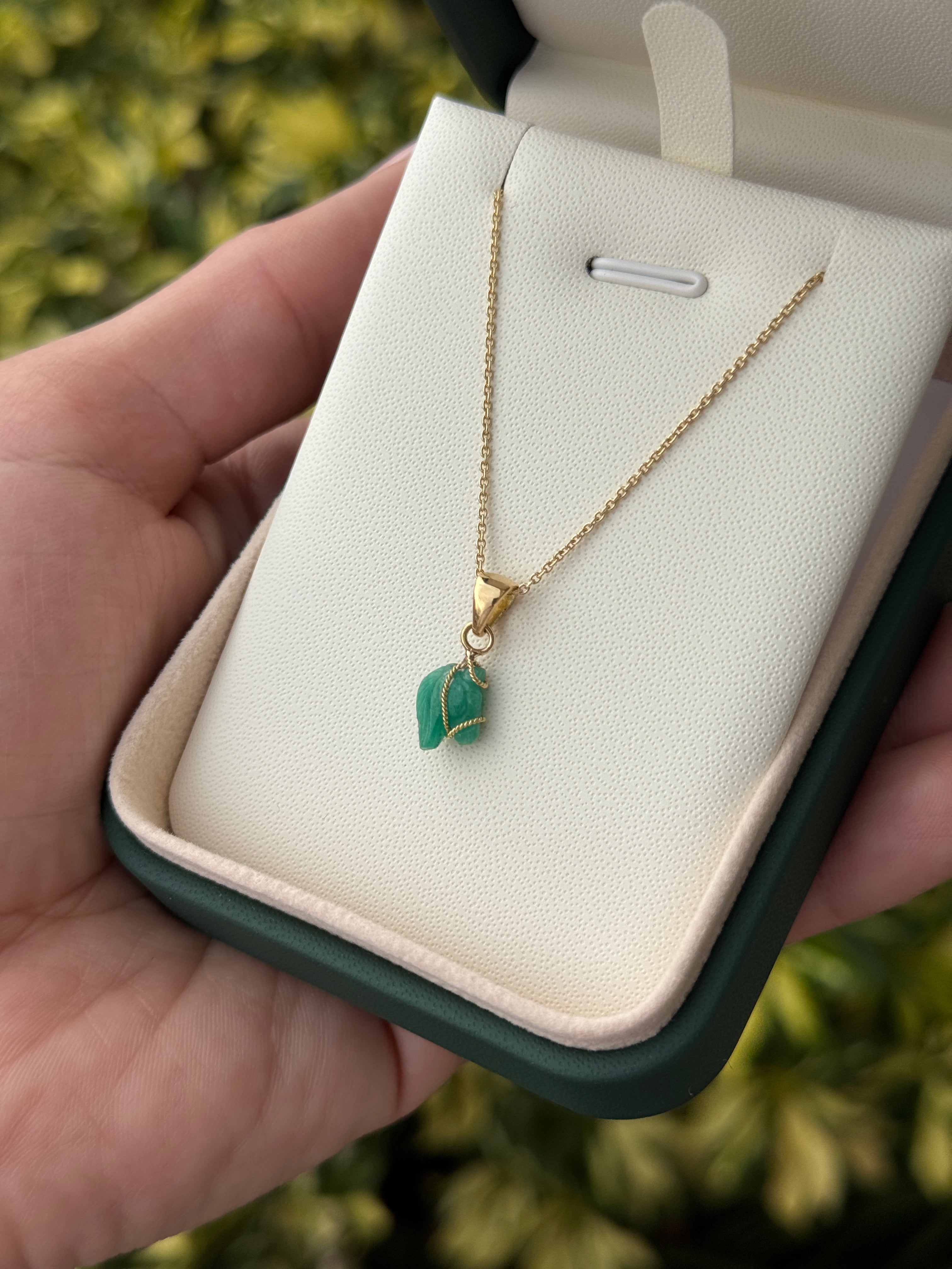 18K necklace featuring a 1.40-carat Chinese New Year horse-shaped Colombian emerald pendant by JR Colombian Emeralds.