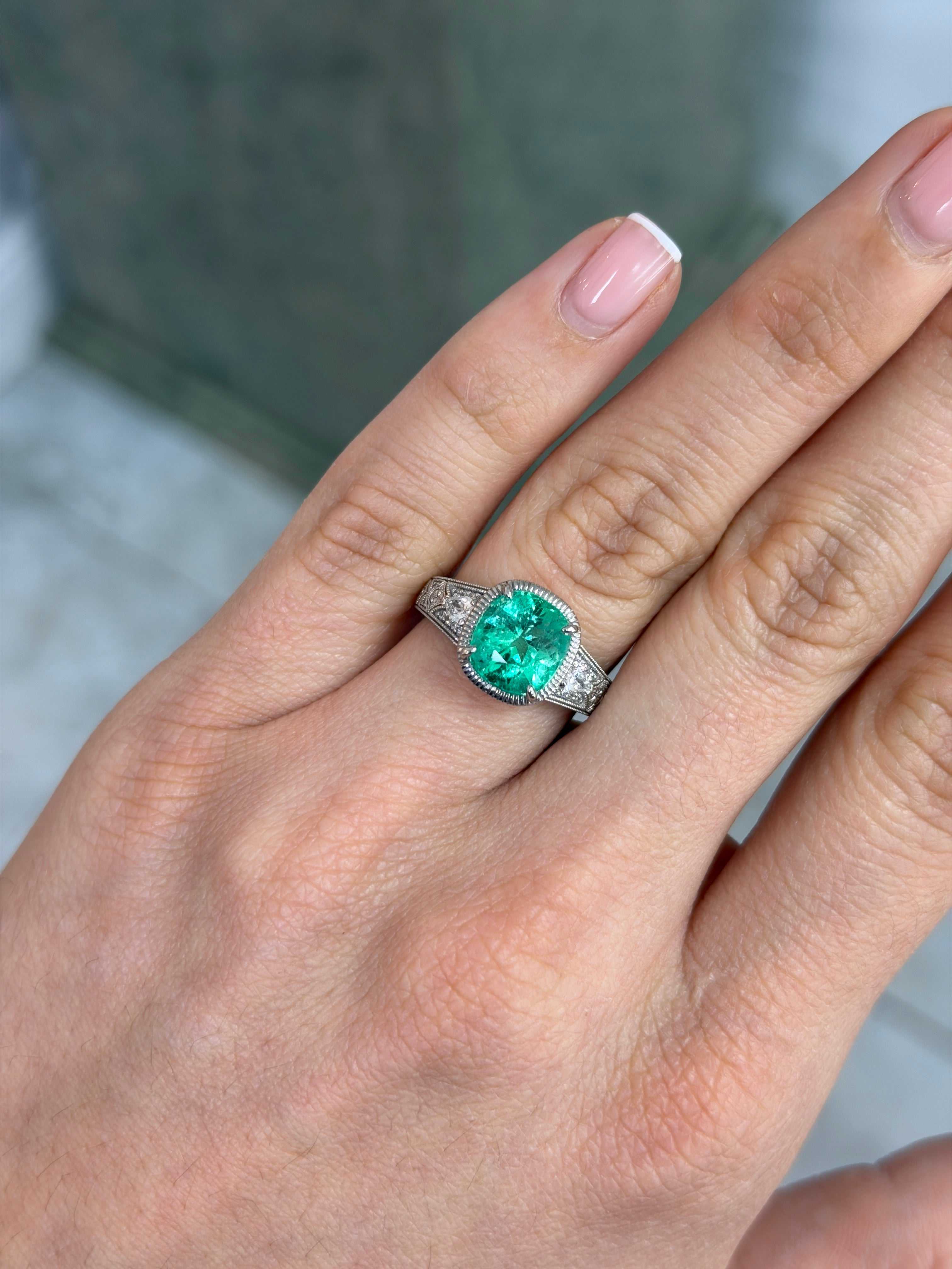 D.C Platinum 3.34 carat cushion emerald and diamond ring in platinum setting on hand