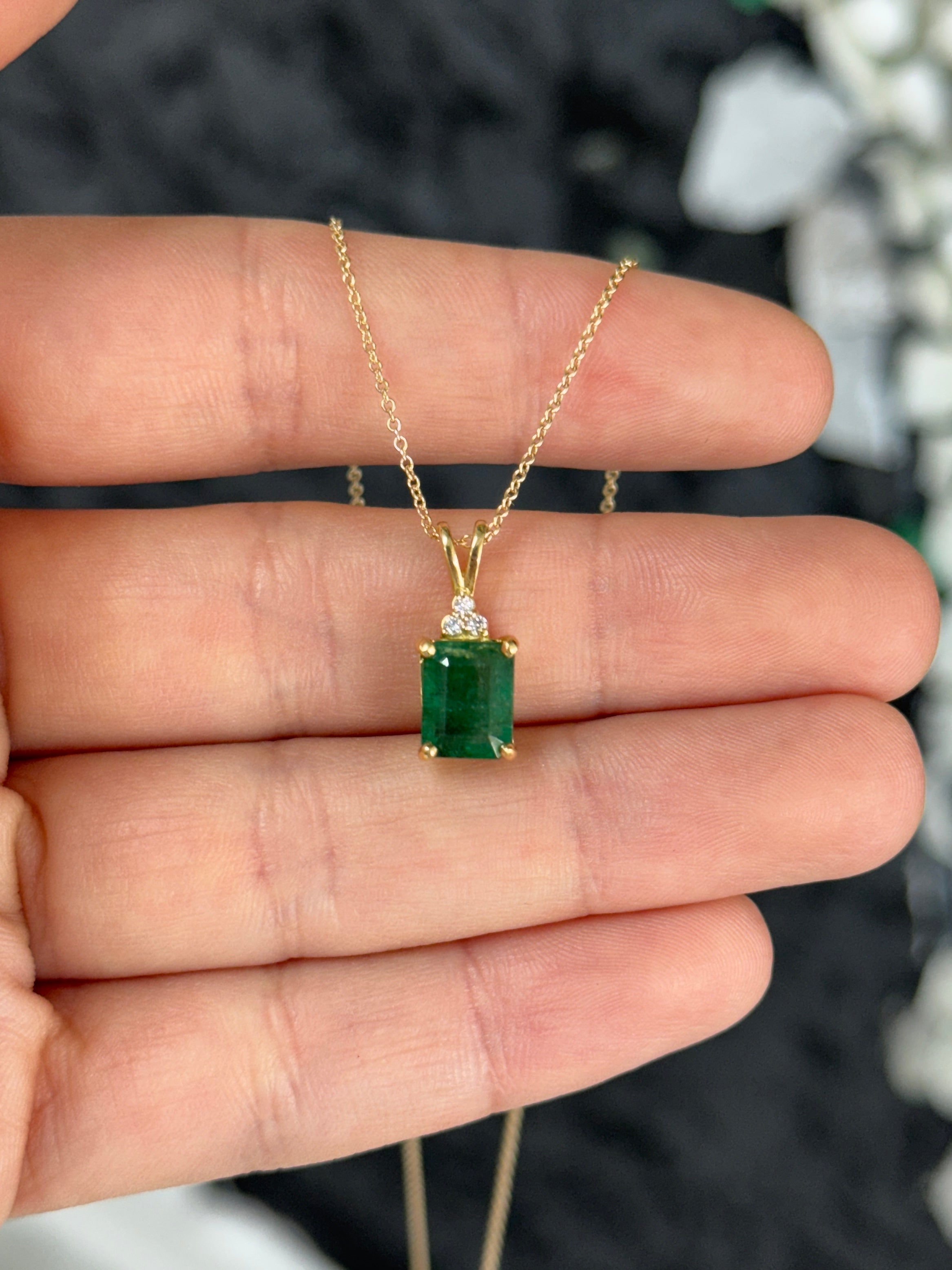 Emerald cut emerald pendant with trefoil diamond accents in 14K gold from JR Colombian Emeralds.