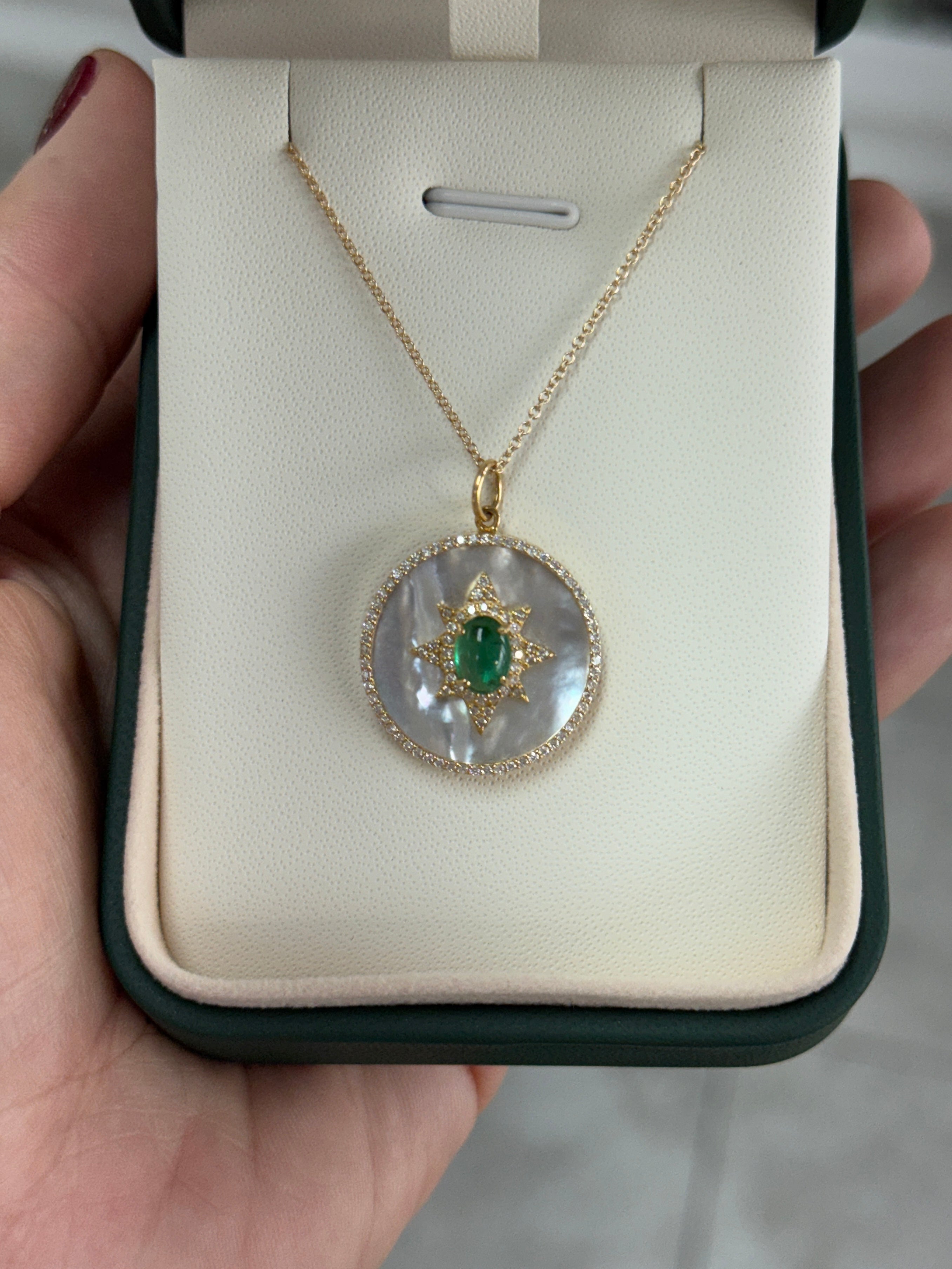 JR Colombian Emeralds starburst medallion featuring 8.89tcw emerald cabochon, mother of pearl, and diamond halo design.