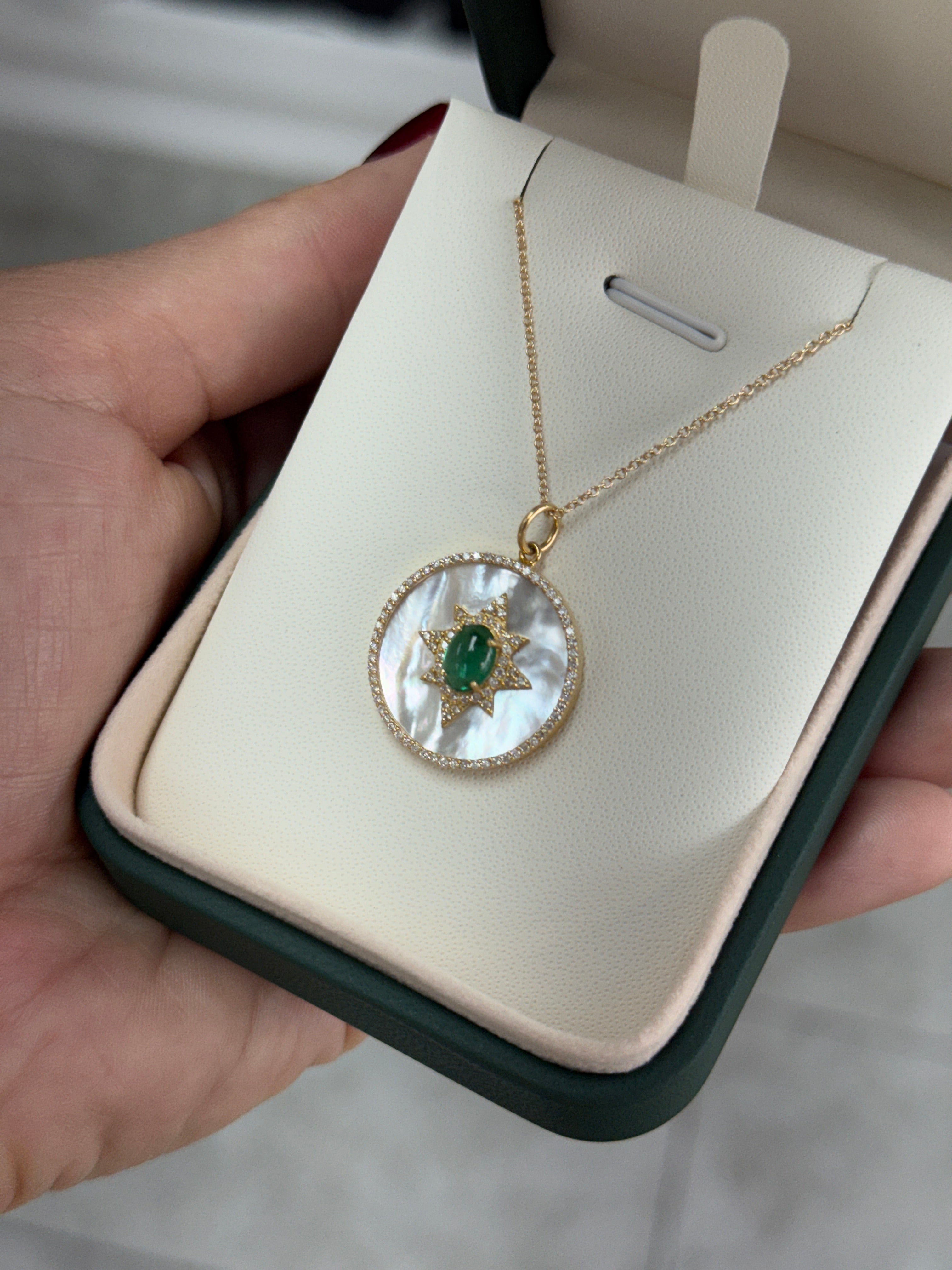 14K gold starburst medallion with emerald cabochon, mother of pearl, and diamond halo by JR Colombian Emeralds.