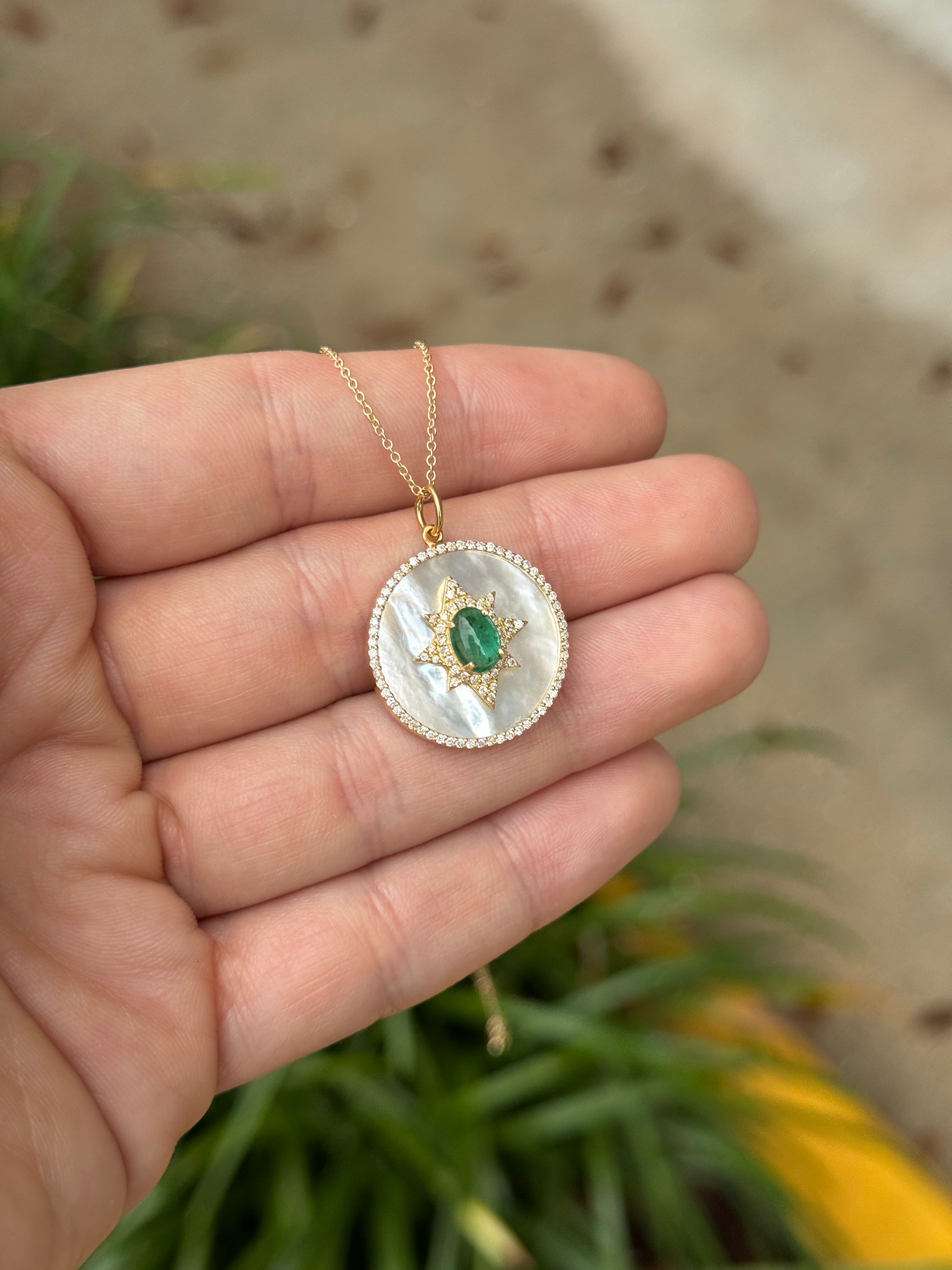 14K gold starburst medallion featuring emerald cabochon, mother of pearl, and diamond halo by JR Colombian Emeralds.