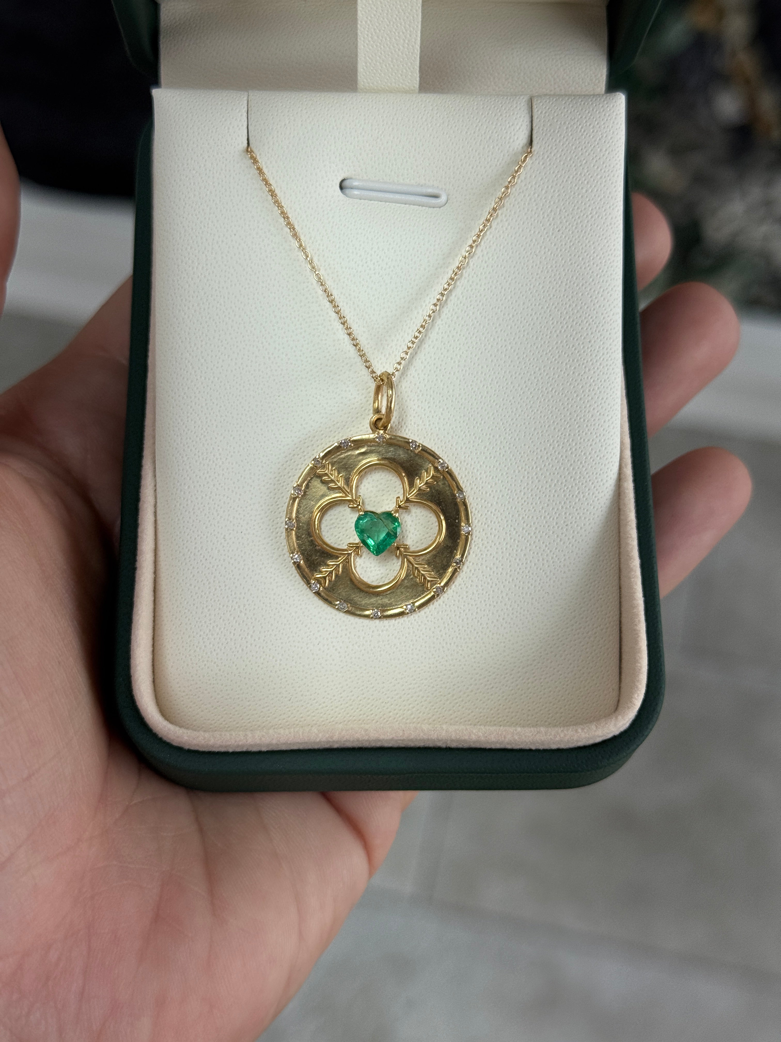 14K gold heart-shaped emerald and diamond motif medallion pendant with 0.86 carats total weight, by JR Colombian Emeralds.