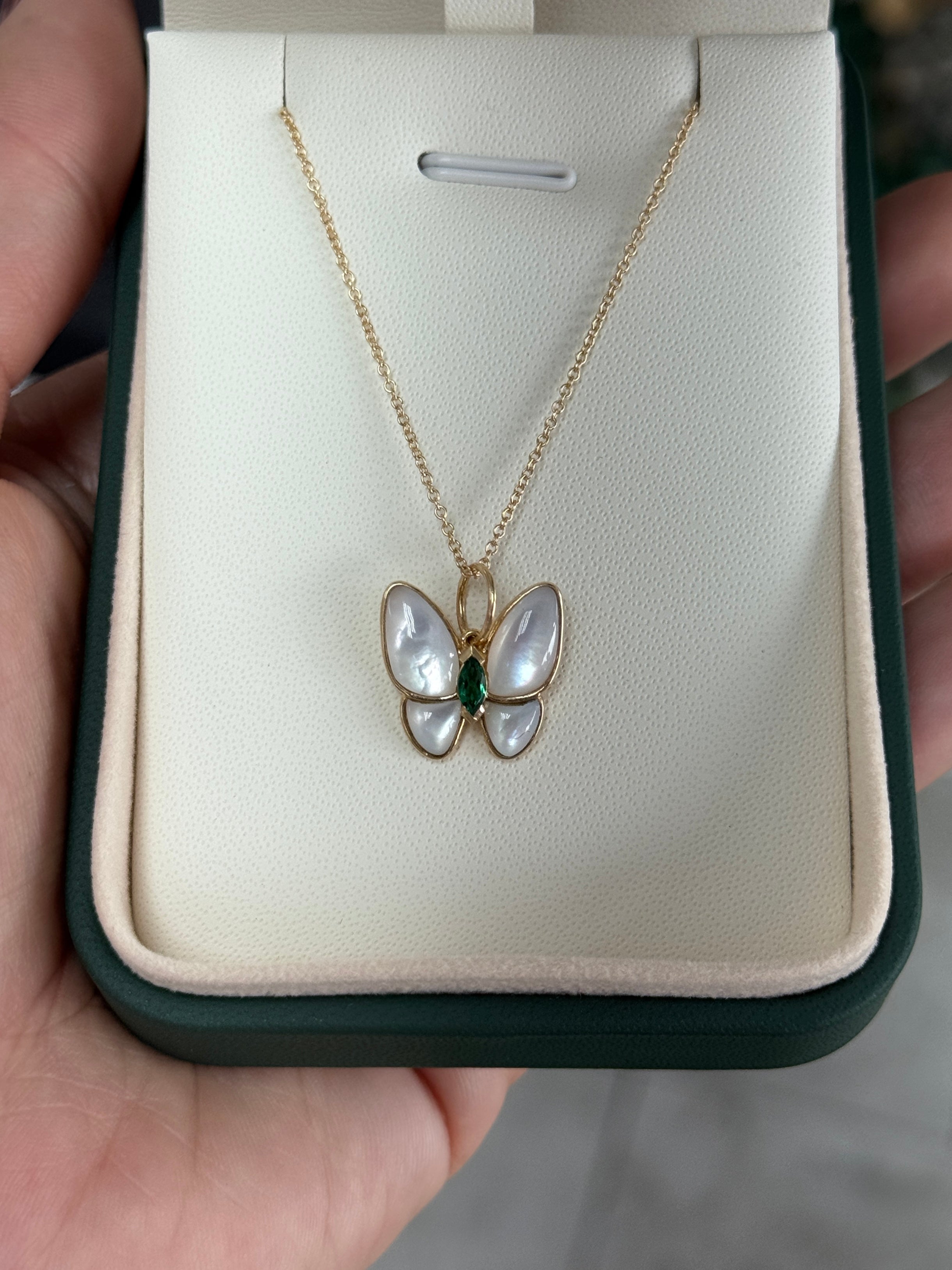 14K gold butterfly pendant with 2.90tcw marquise emeralds and mother of pearl, crafted by JR Colombian Emeralds.