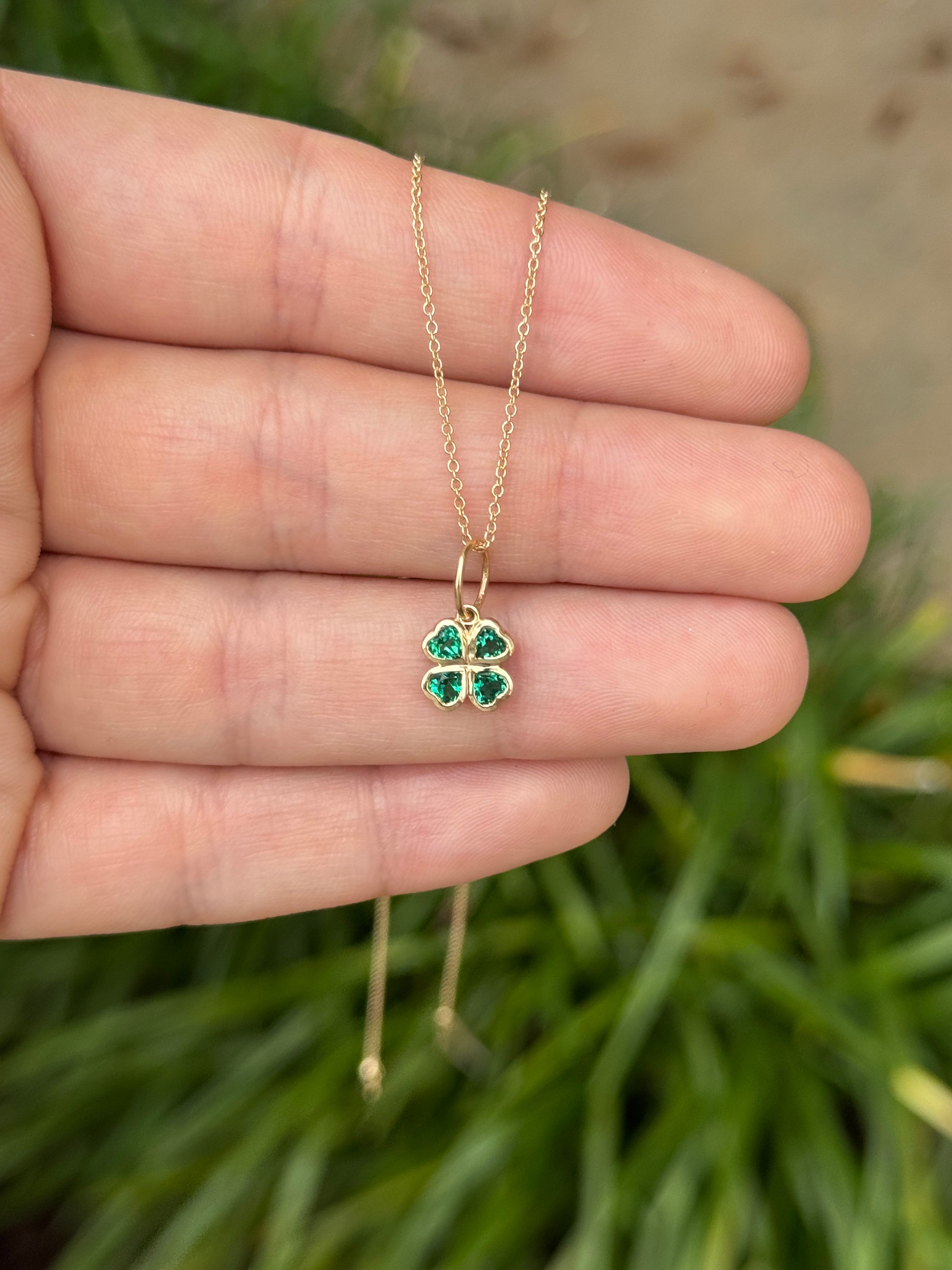 14K gold emerald clover charm pendant with a 0.44tcw heart-cut Colombian emerald, jewelry from JR Colombian Emeralds.