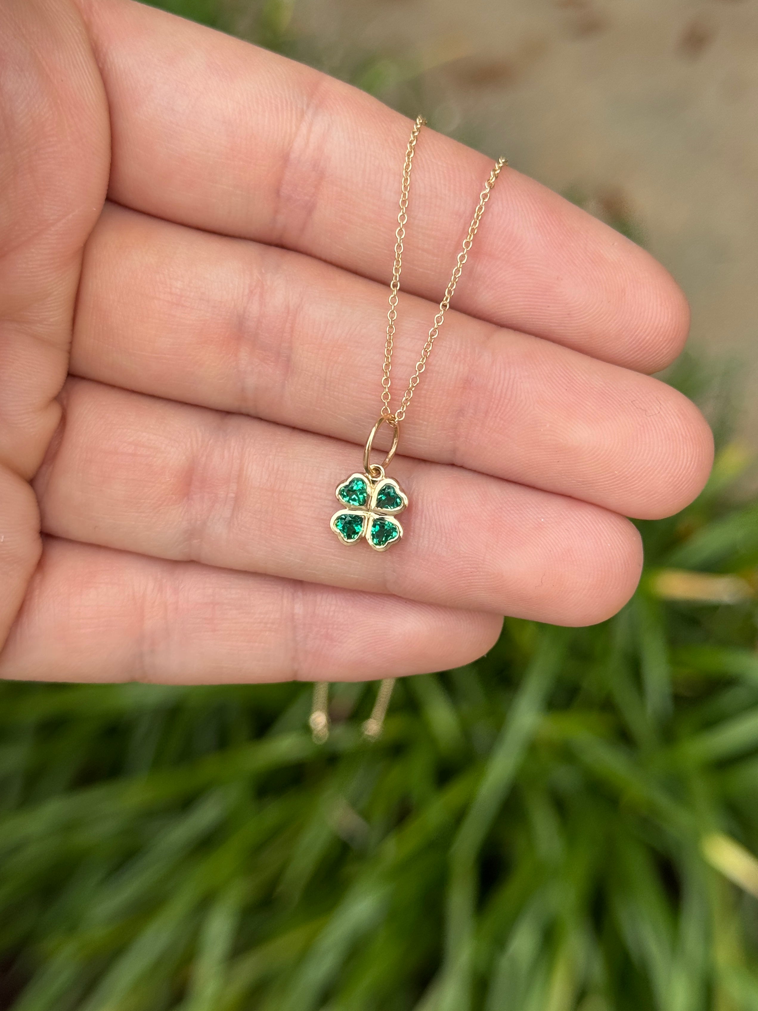 14K gold heart cut emerald clover charm pendant with 0.44 carats AAA+ quality emeralds, featuring a delicate and intricate design.