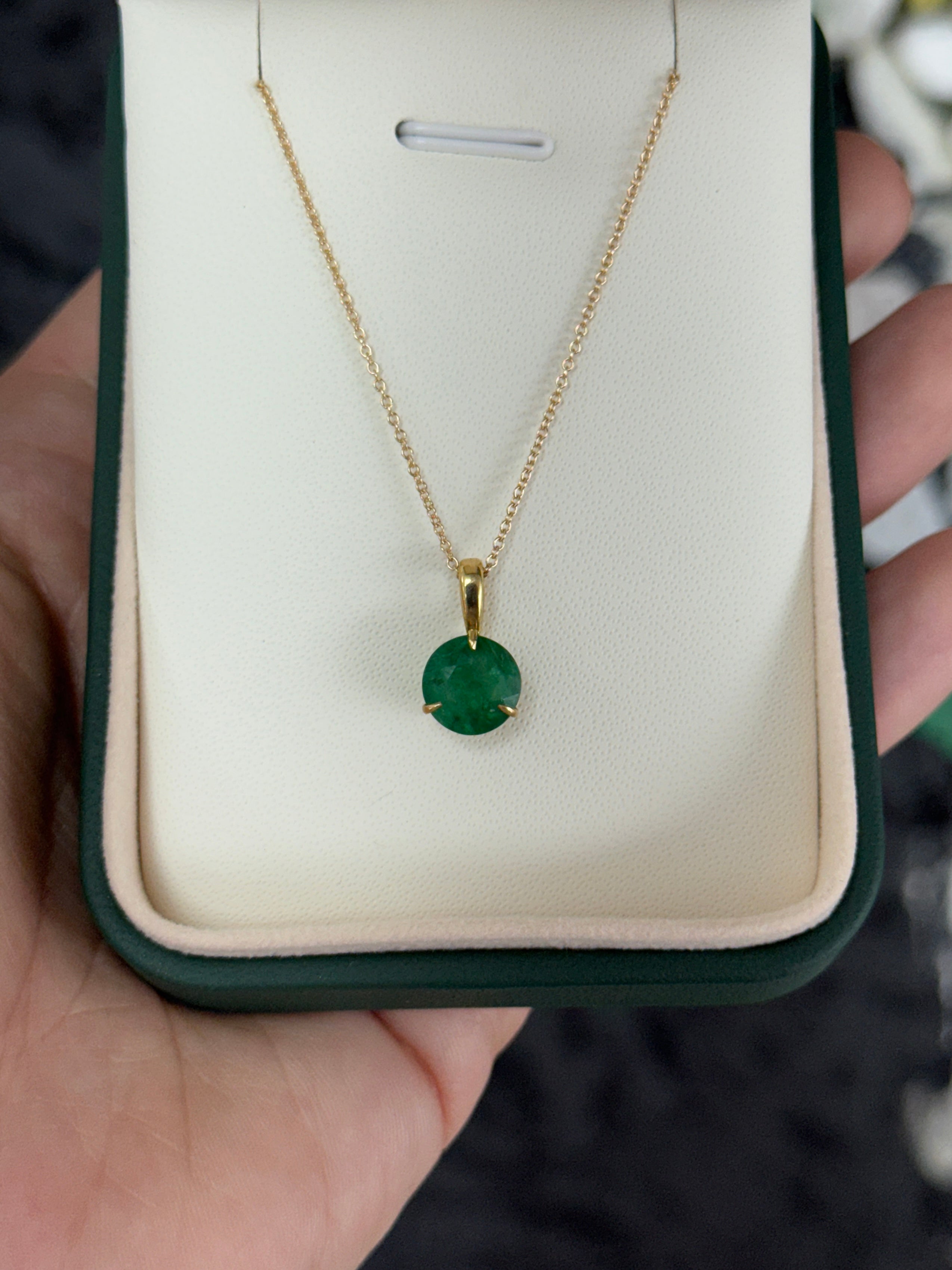 14K gold emerald solitaire necklace featuring a 1.66ct round emerald in a three-prong setting by JR Colombian Emeralds.