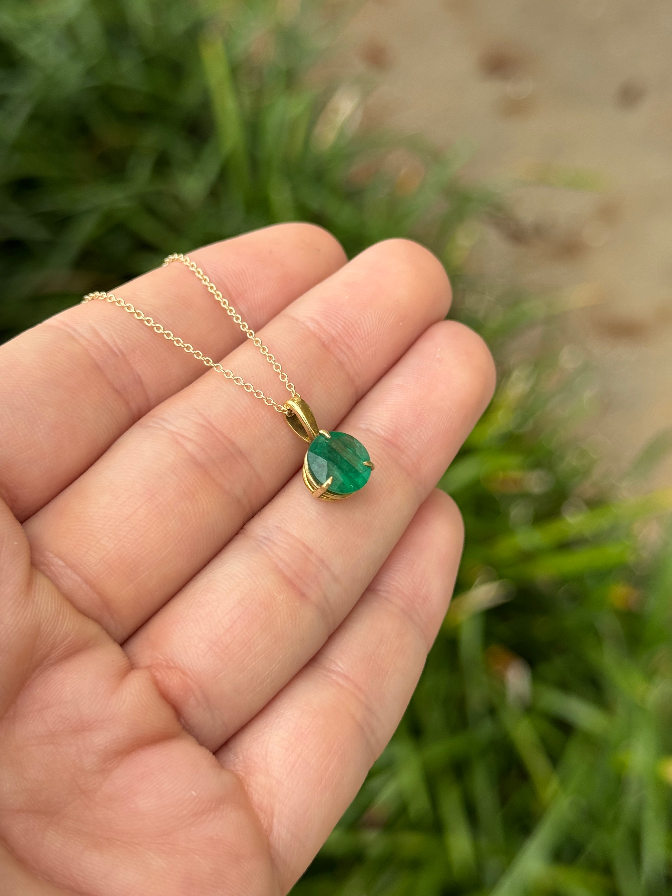14K gold three-prong round emerald solitaire necklace with a 1.66-carat JR Colombian emerald, displayed on a white background.