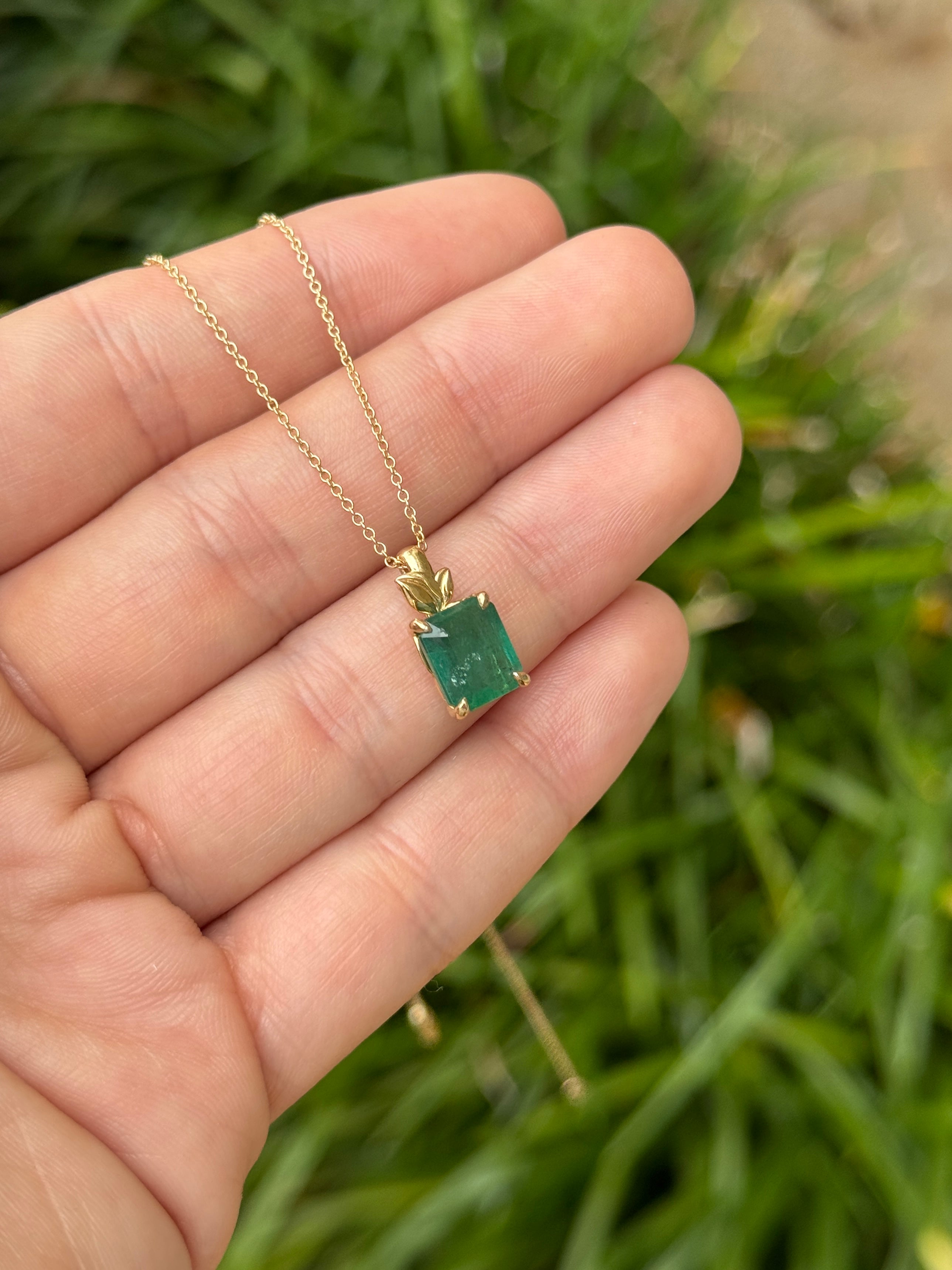 Emerald cut emerald pendant with leaf design and gold bail, natural-inspired jewelry by JR Colombian Emeralds.