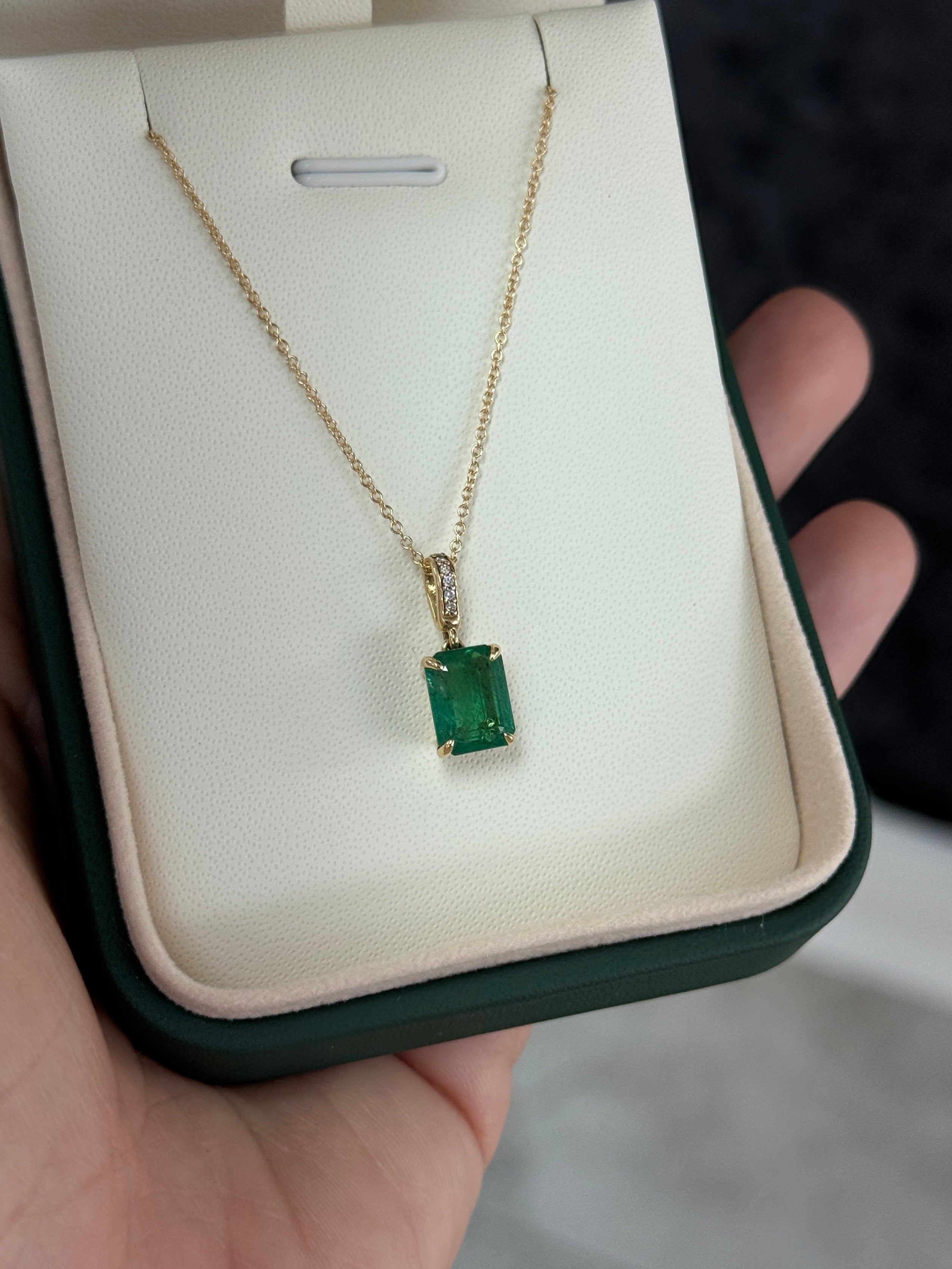 Emerald cut emerald pendant with diamond bail in 14K gold, showcasing a 1.79tcw gem by JR Colombian Emeralds.