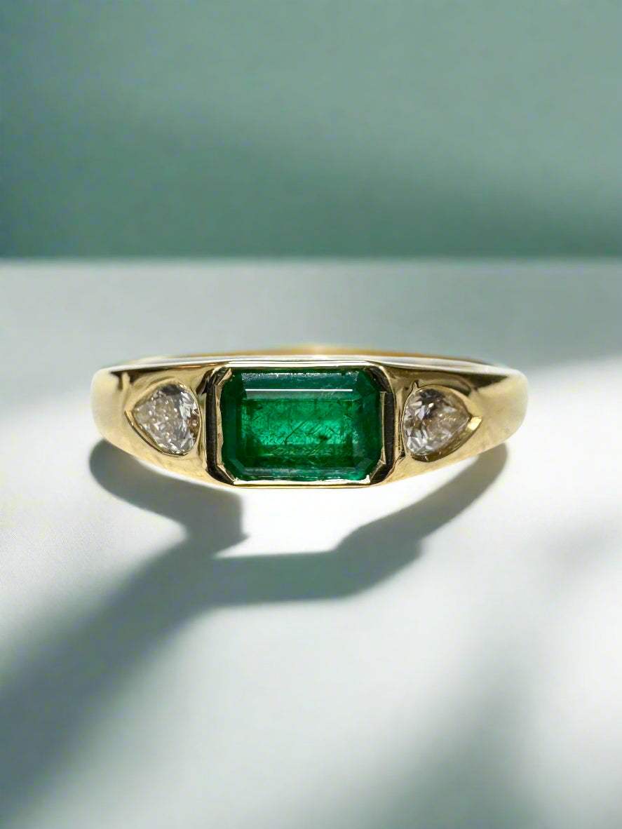 0.91tcw 18K yellow gold ring with emerald cut emerald and pear-shaped diamond three-stone band