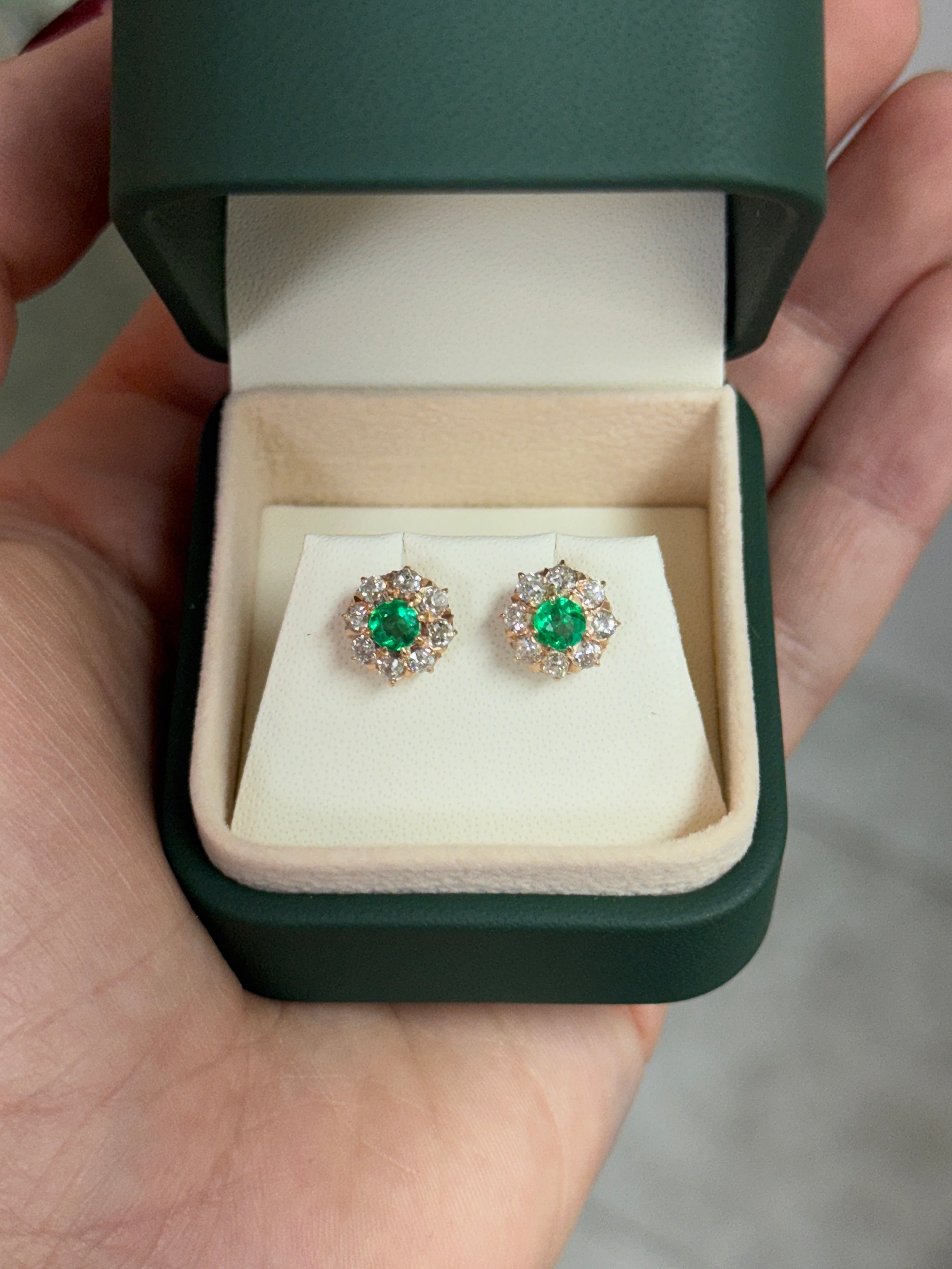 Vivid Colombian emerald halo stud earrings with old European cut diamonds in 14K gold, featuring 2.10 carats total weight.