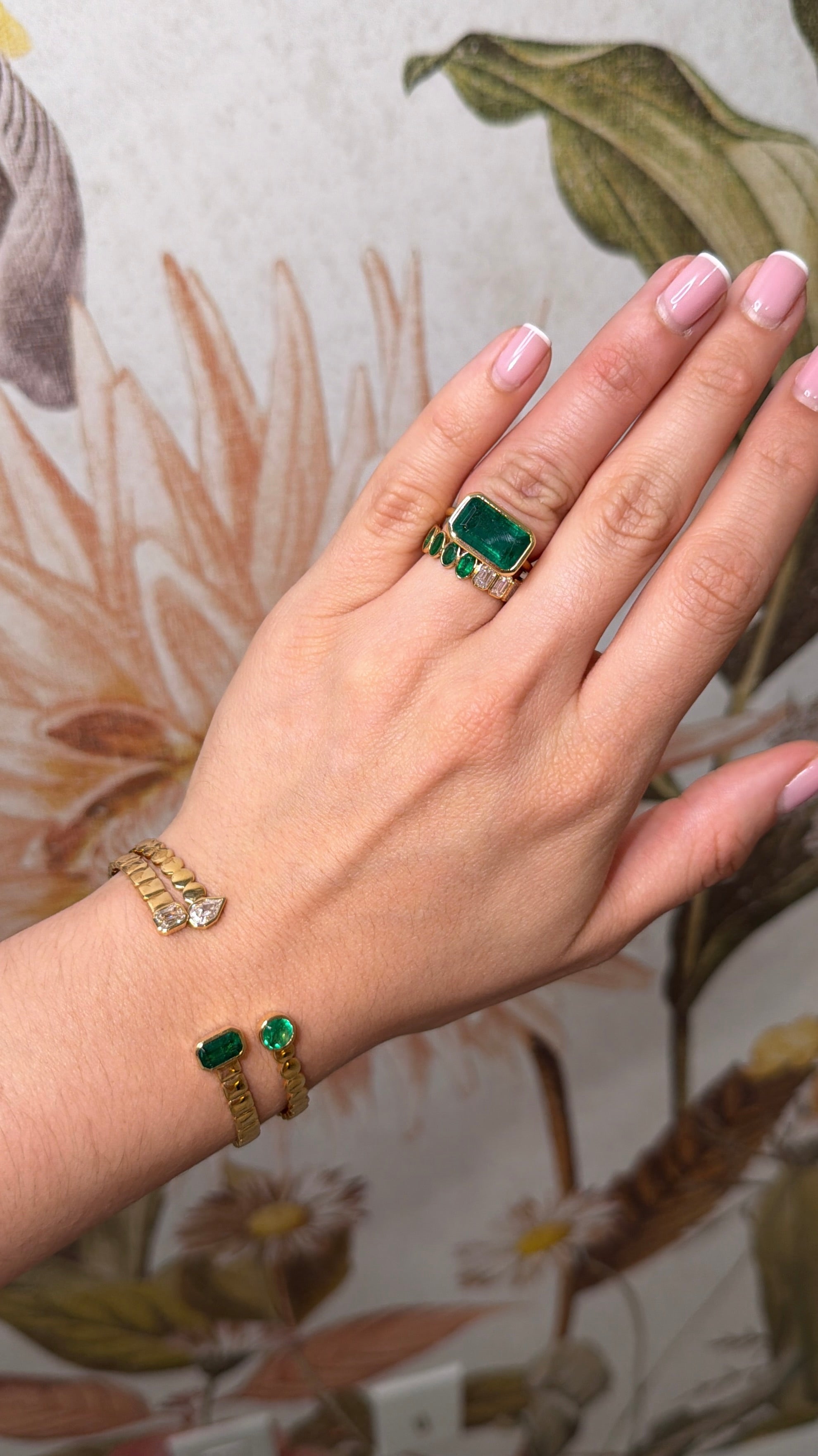 Ladies emerald ring featuring a 5.48ct deep green Colombian emerald bezel set in 18K gold, designed as an east-to-west solitaire.