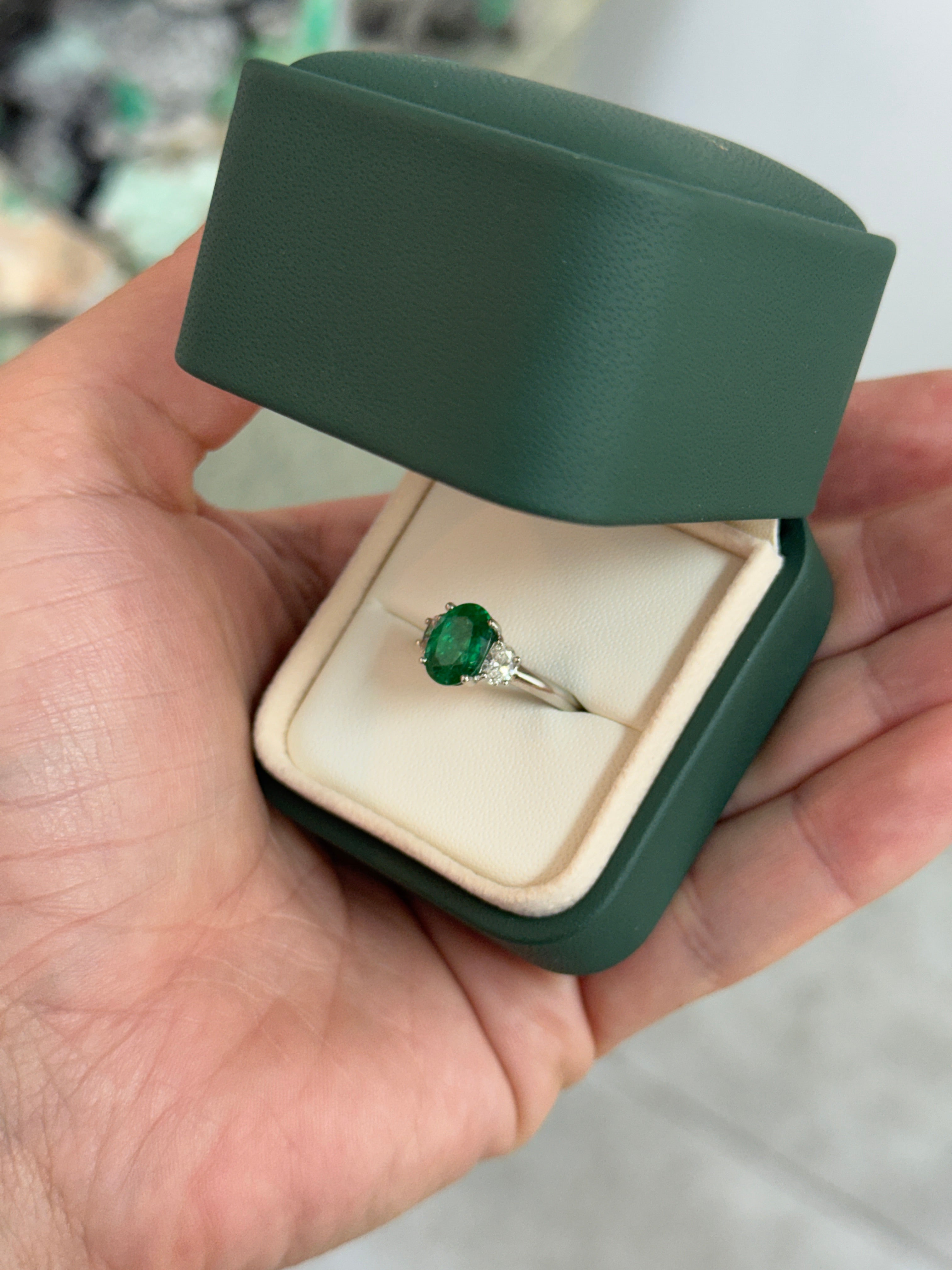 Vivid green oval emerald and diamond three-stone ring in platinum, featuring a 2.97 carat total weight, by JR Colombian Emeralds.