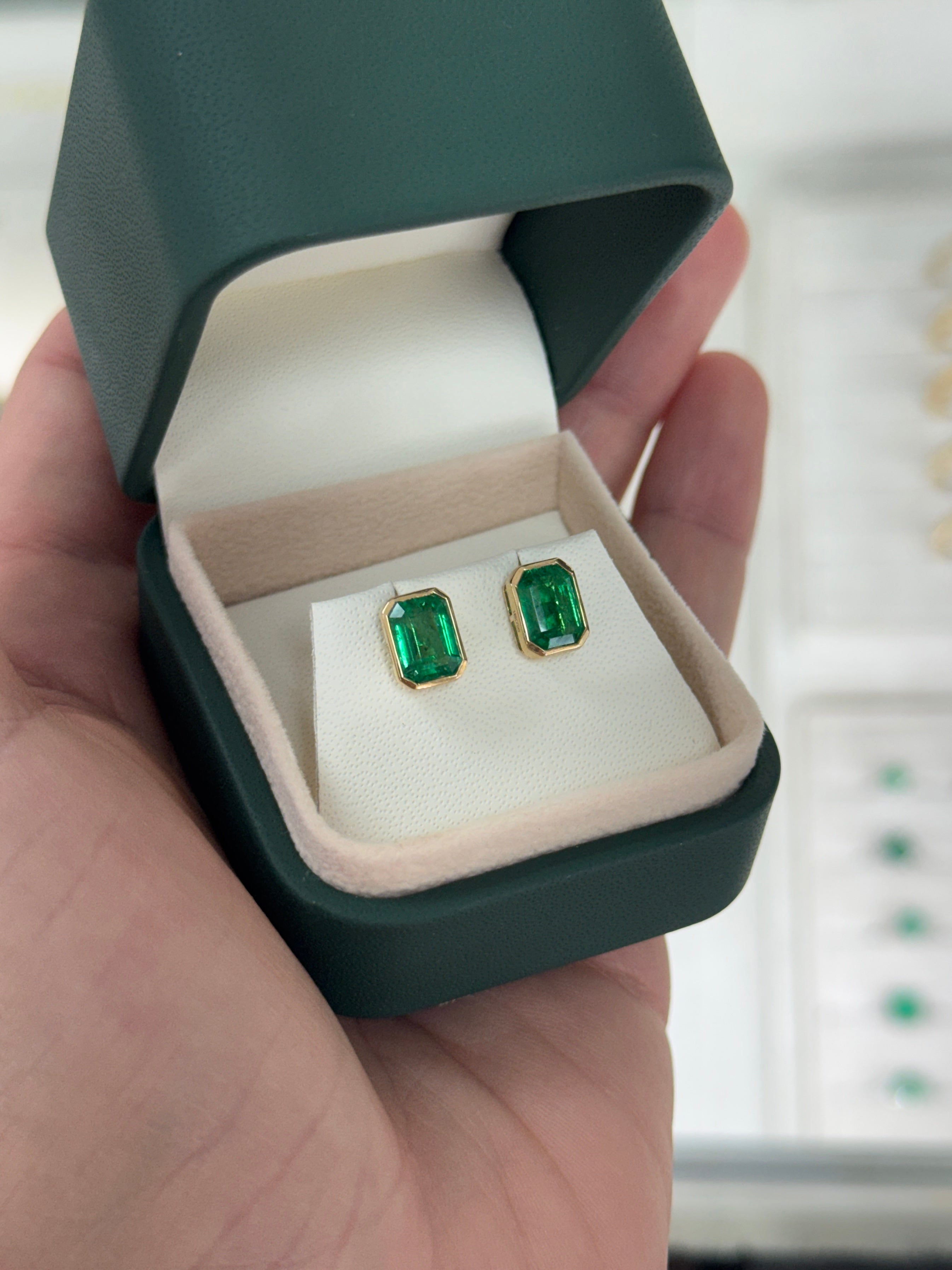 Angelina Jolie bezel set emerald stud earrings with 3.33tcw JR Colombian Emeralds in 18K gold, showcasing vibrant green emeralds.