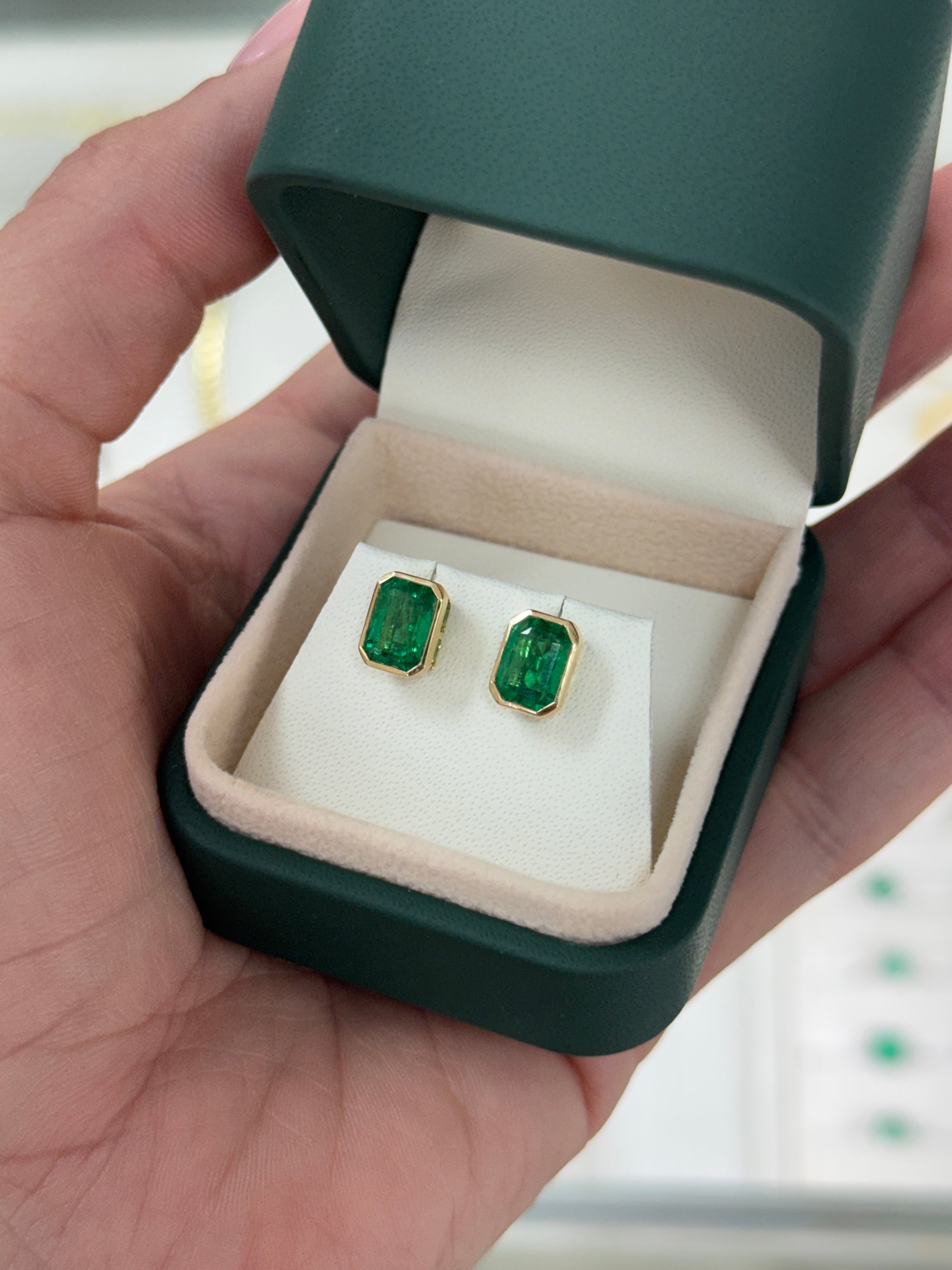 JR Colombian Emeralds 3.33tcw Angelina Jolie bezel set emerald stud earrings in 18K gold featuring vibrant green emeralds.