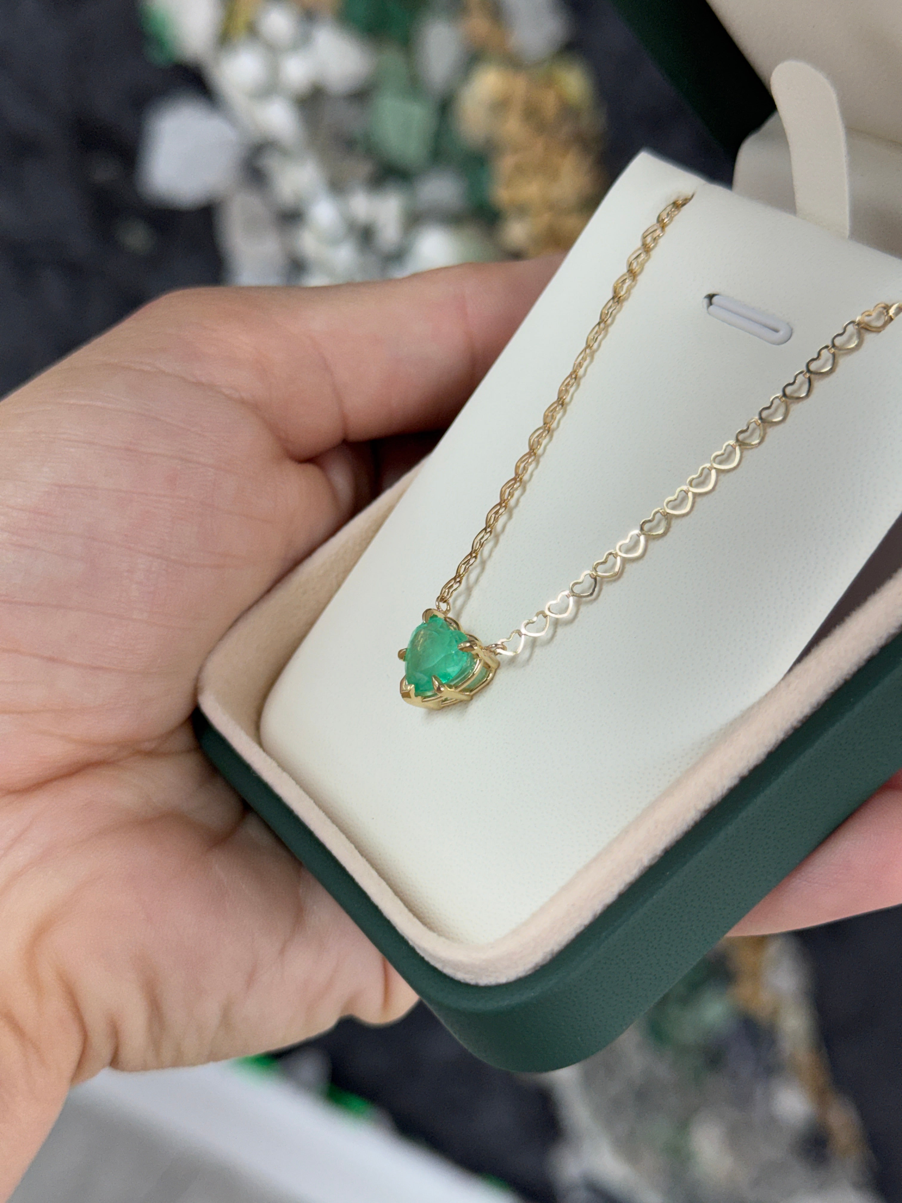 Natural Colombian emerald heart pendant on a 14K necklace with solitaire setting from JR Colombian Emeralds.