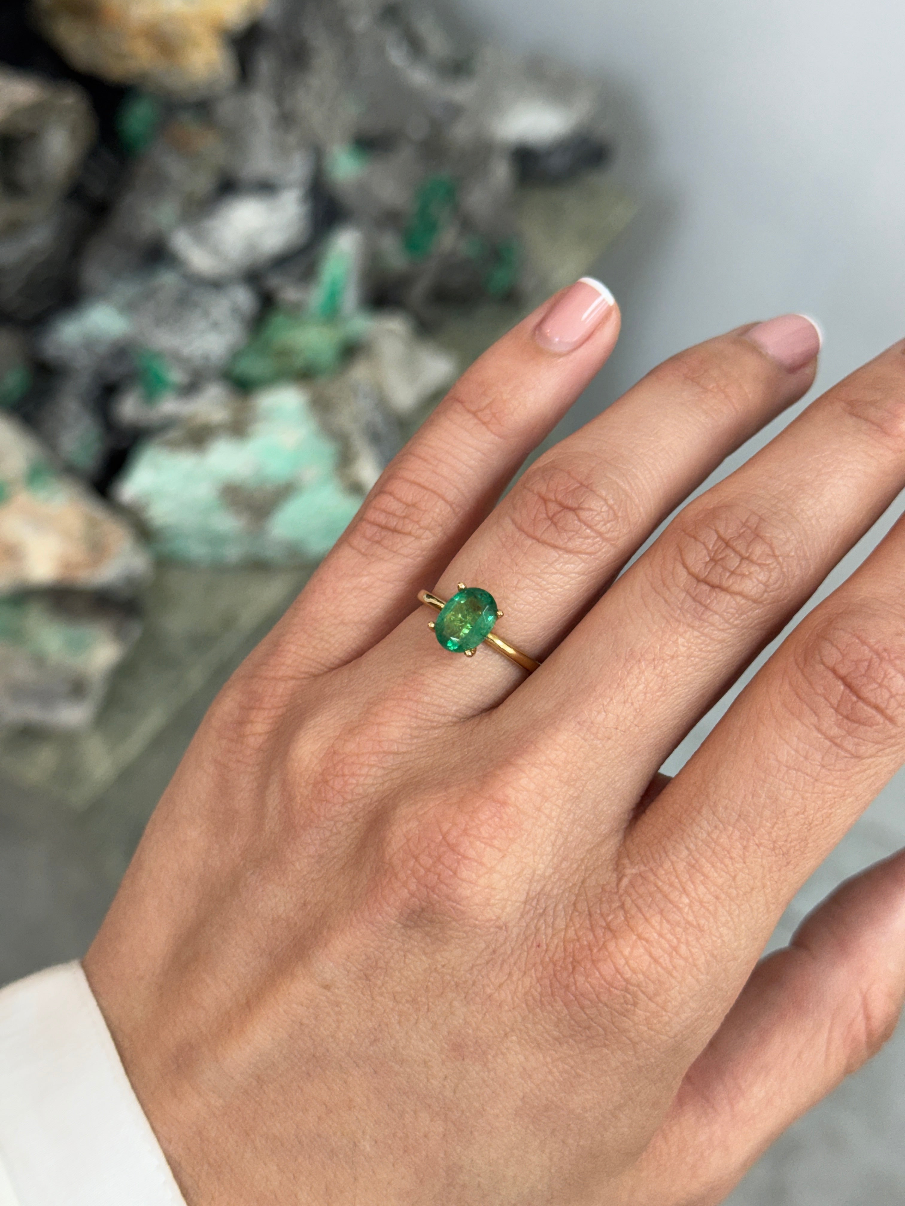 Natural 1.43 carat emerald oval cut solitaire engagement ring in 18K gold by JR Colombian Emeralds, featuring a four-prong setting.