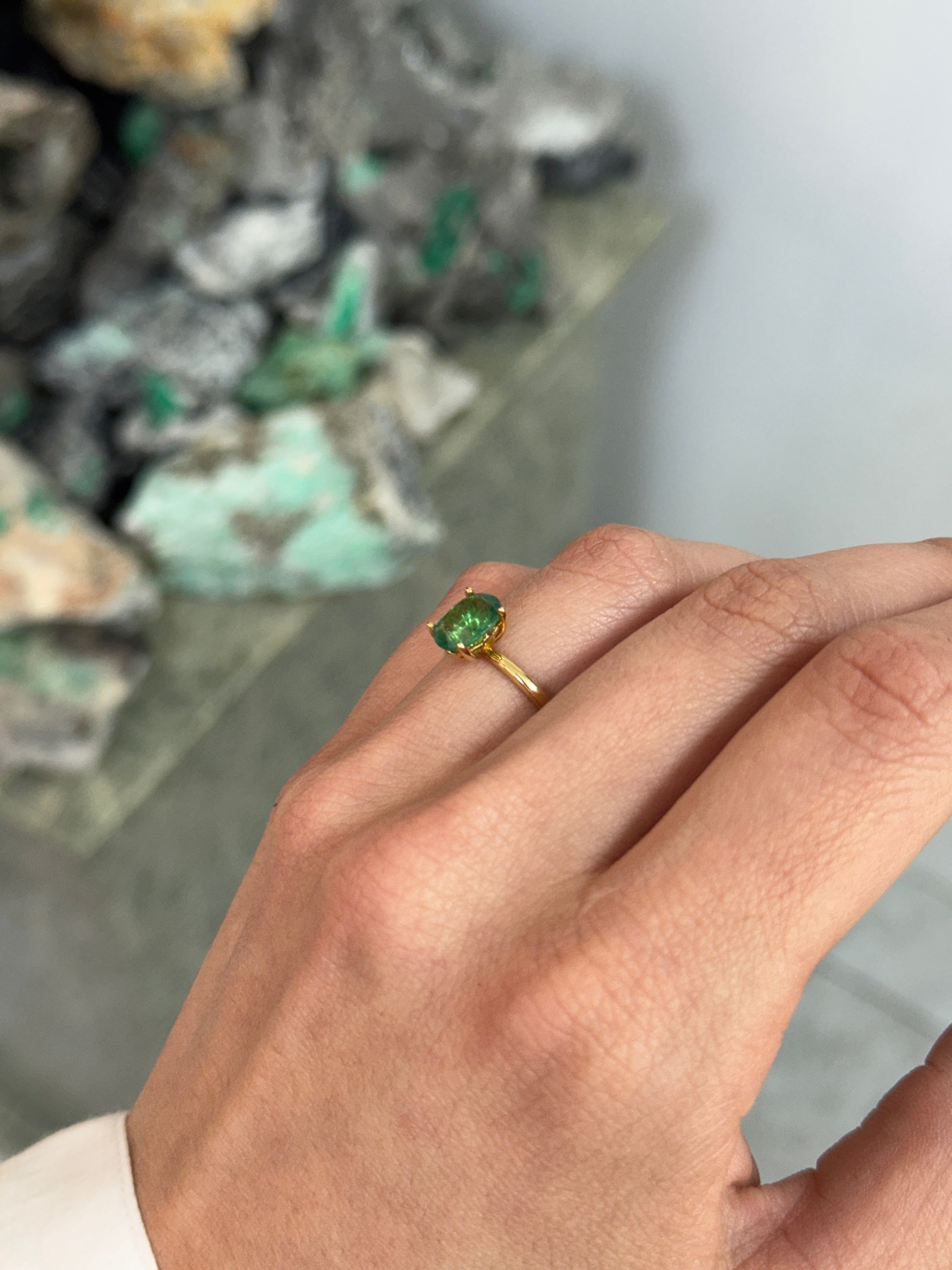 Oval cut 1.43 carat natural emerald solitaire engagement ring in 18K gold with four prongs by JR Colombian Emeralds.