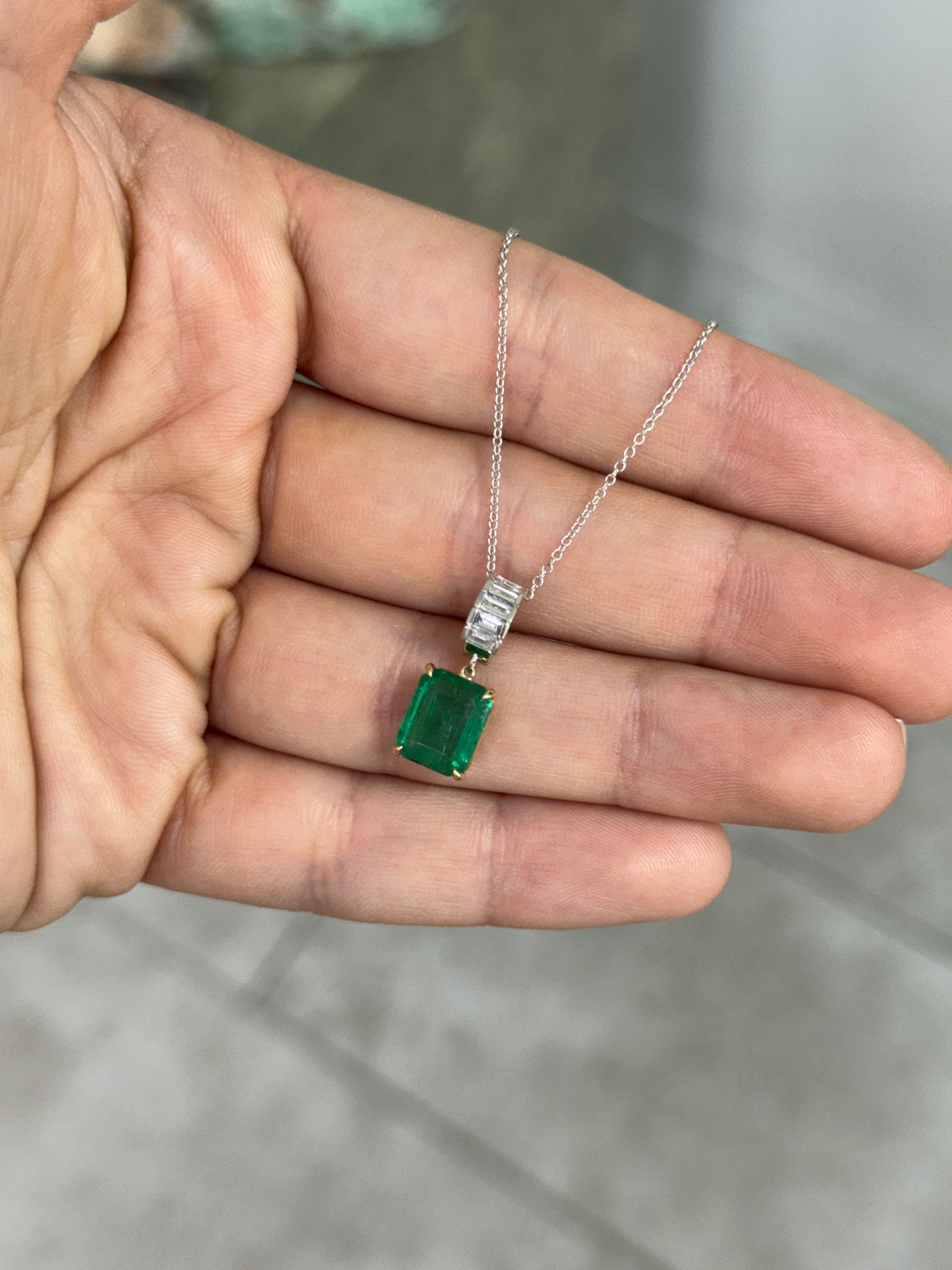 Natural emerald and lab diamond bail pendant with 3.57tcw in 14K gold, featuring classic emerald and baguette diamond accents.