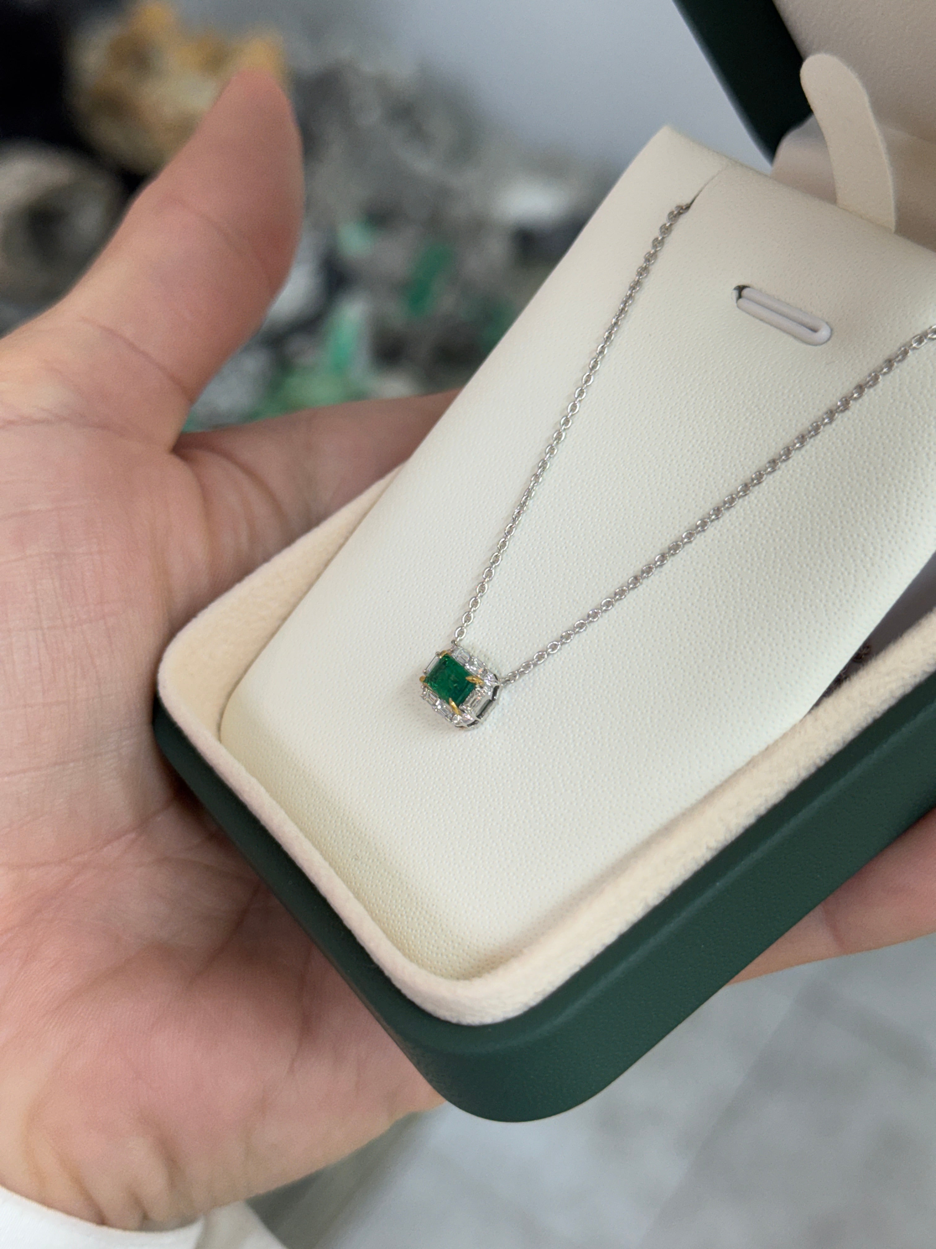 AAA+ natural emerald and baguette diamond halo necklace in 18K gold, east-to-west station design by JR Colombian Emeralds.