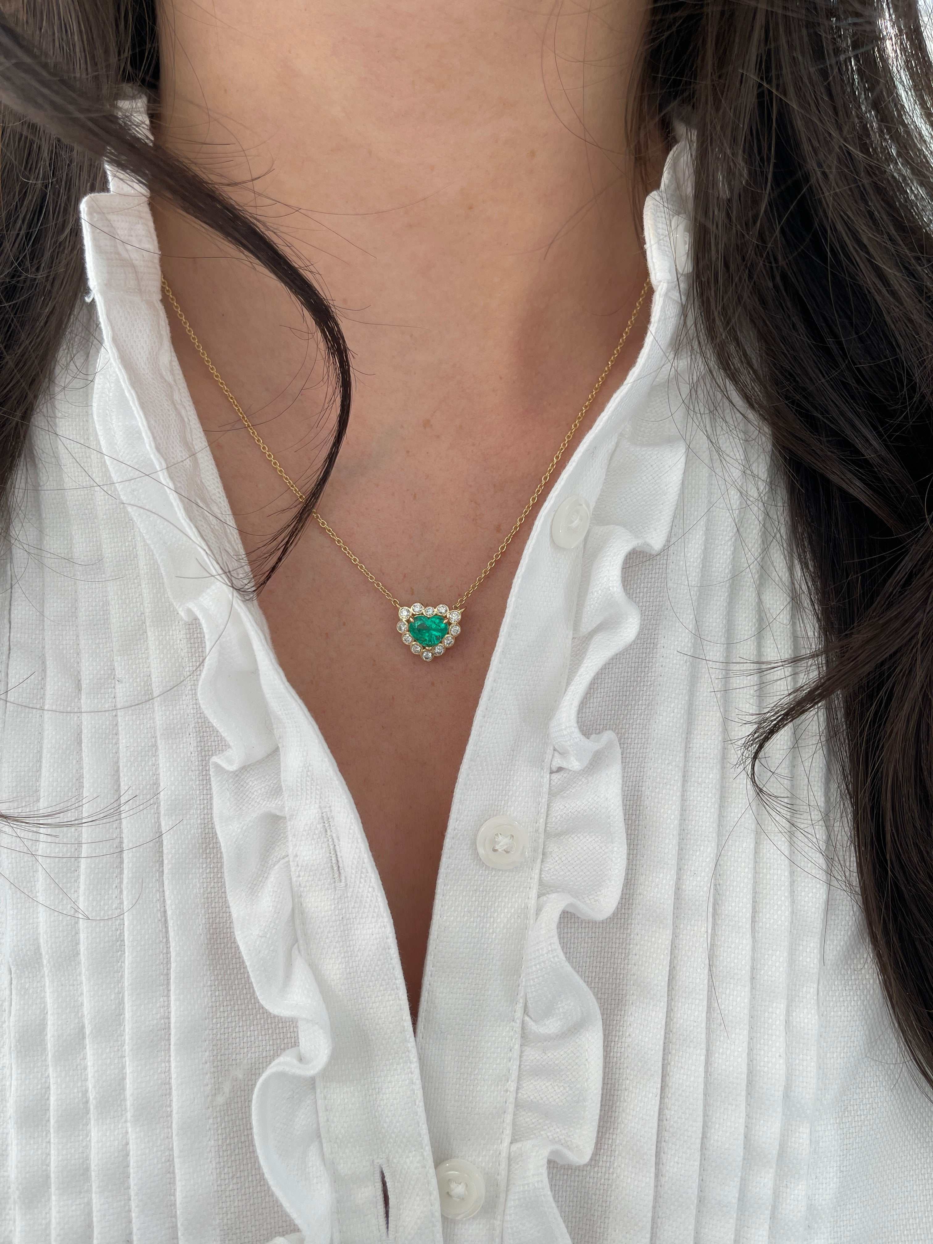 2.24tcw Colombian Emerald Heart & Diamond Bubble Halo Necklace in 18K Yellow Gold on model.