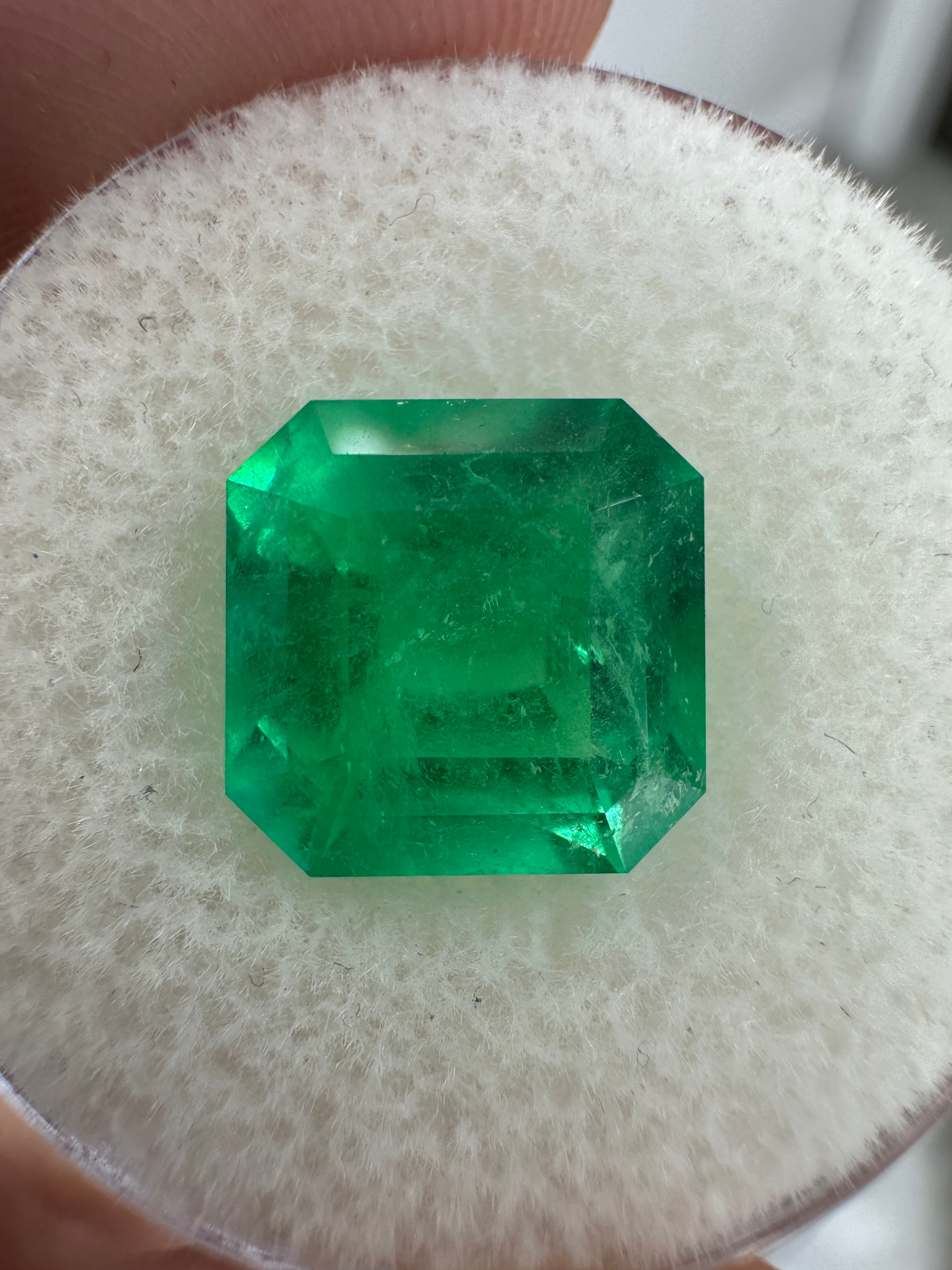 4.35 carat 10x10 mm Colombian emerald loose gemstone with Kyptonite glow and Asscher cut, showcased by JR Colombian Emeralds.