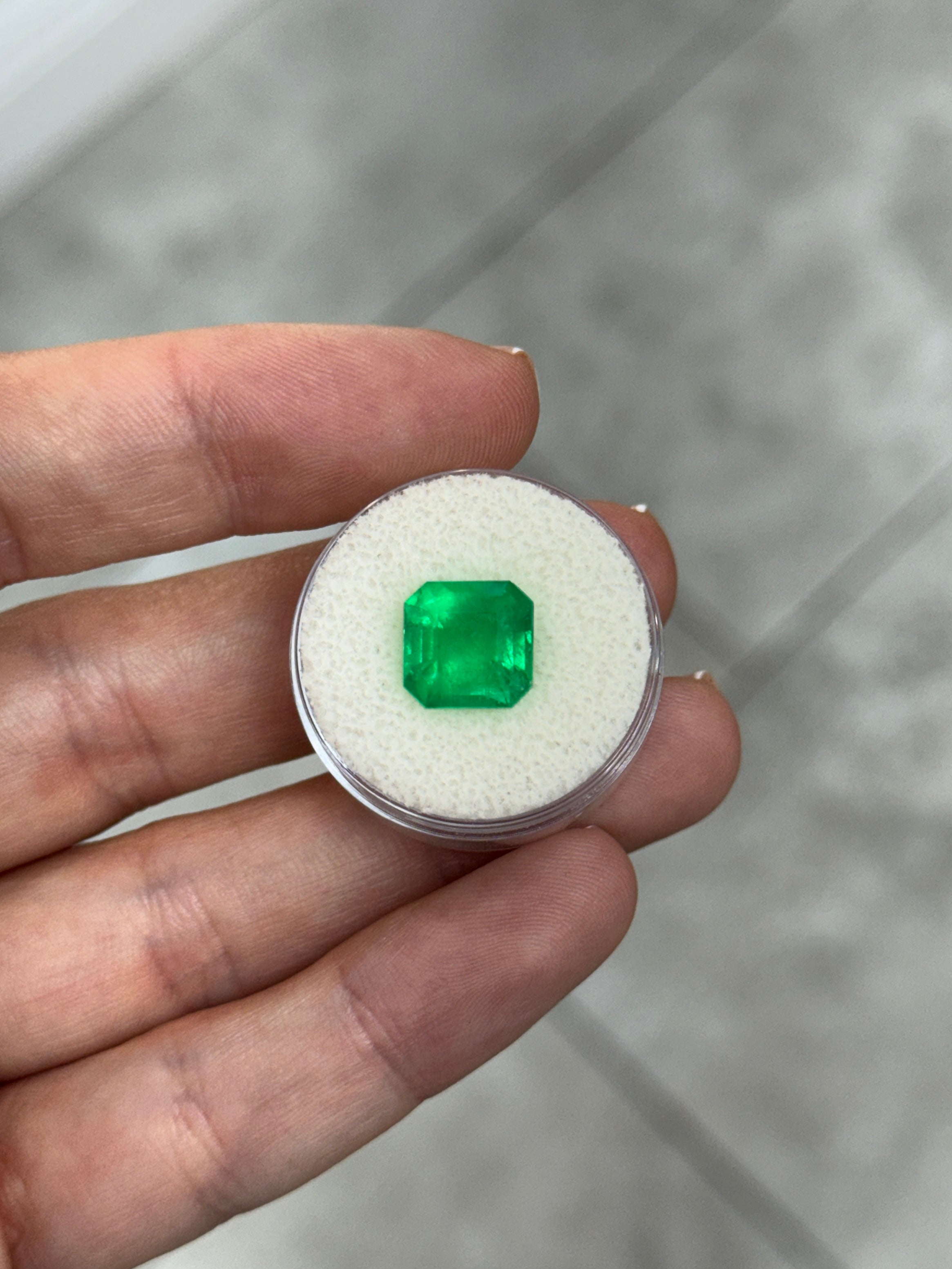 4.35 carat Kryptonite glow Colombian emerald Asscher cut loose gemstone with vibrant green color and intricate facets.
