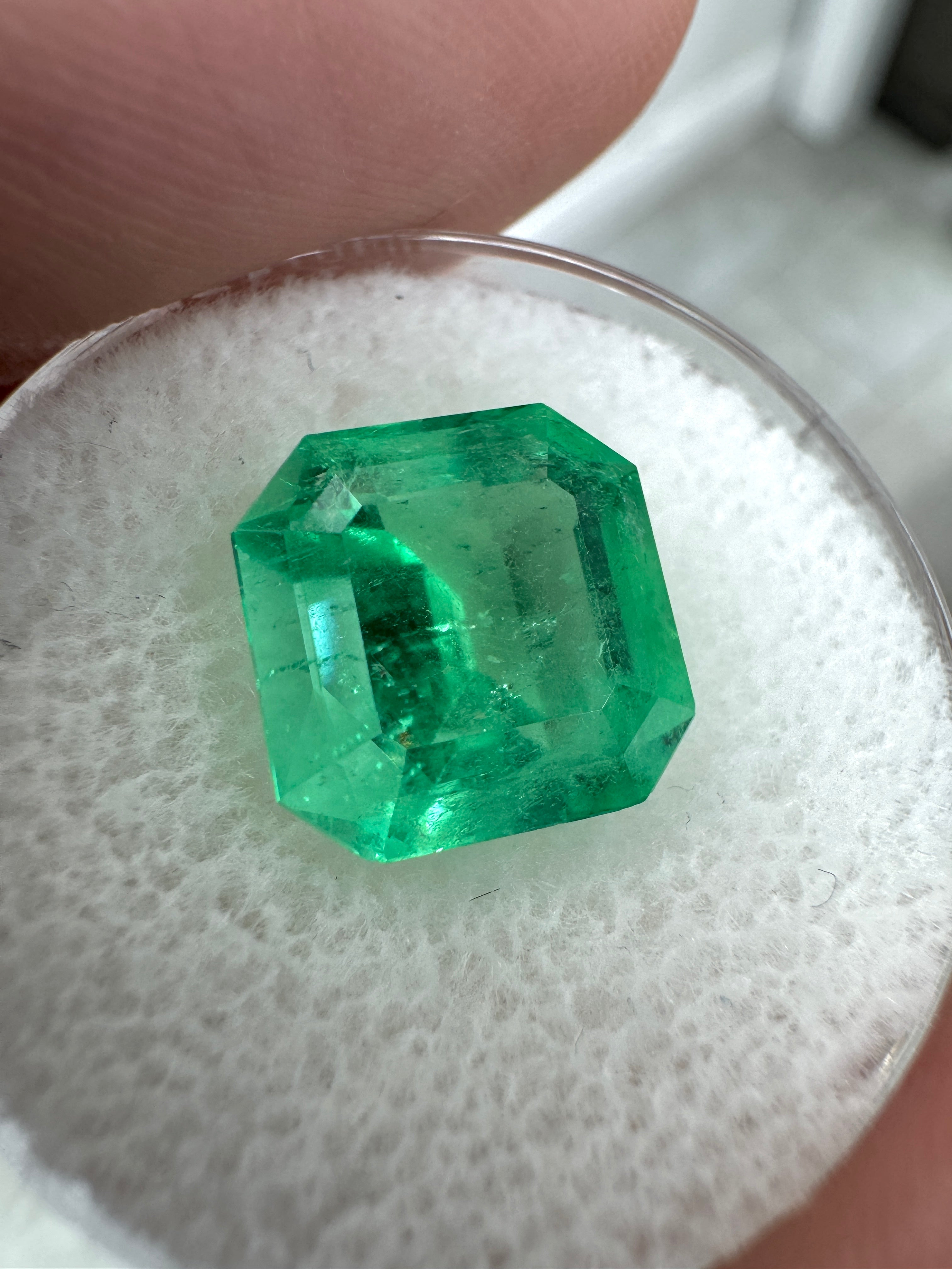 4.57 carat Colombian emerald loose gemstone with Asscher cut and clipped corners, glowing green color, by JR Colombian Emeralds.