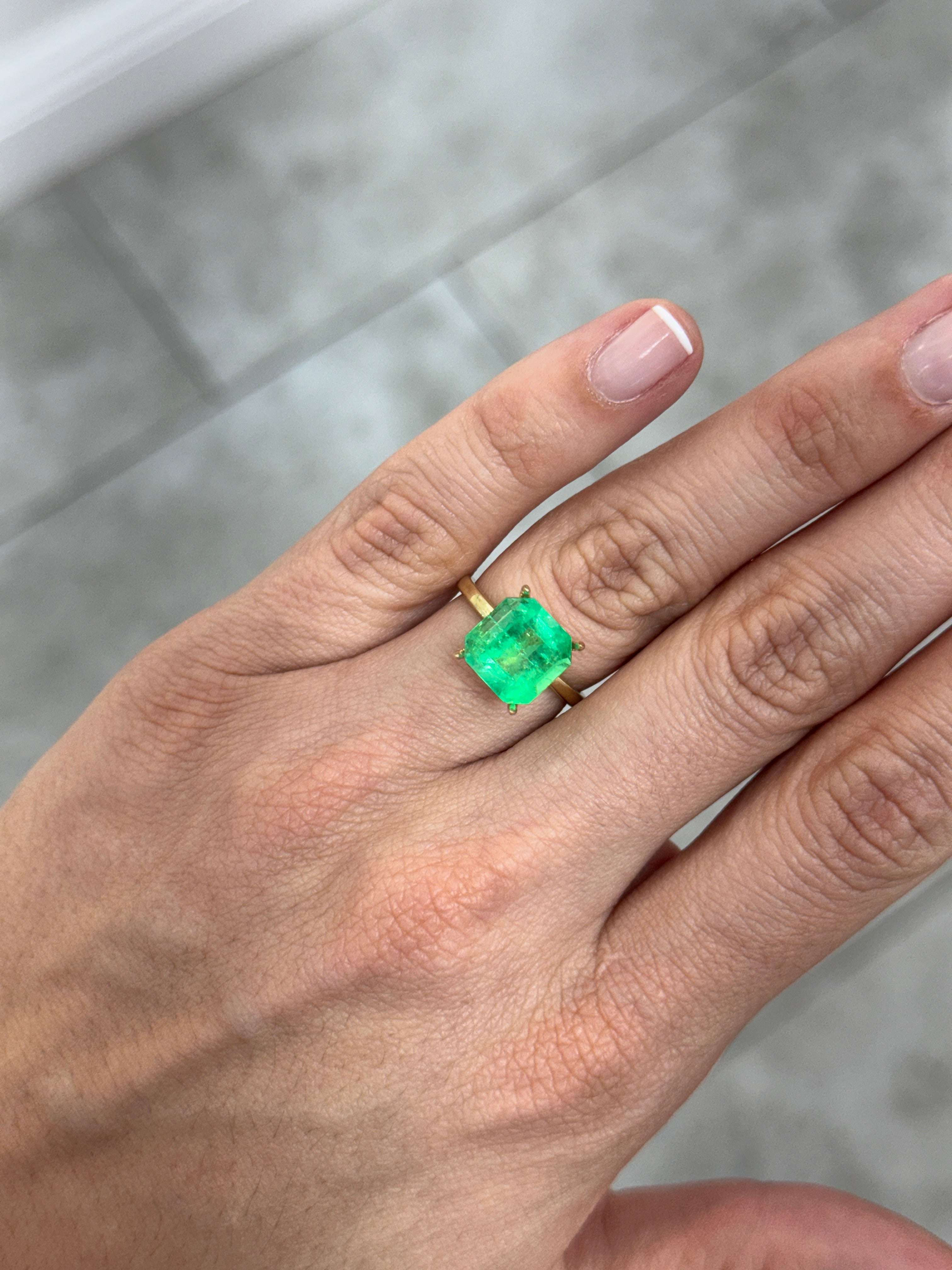 4.57 Carat 10x10mm Colombian Emerald Asscher cut with clipped corners, glowing loose gemstone from JR Colombian Emeralds.