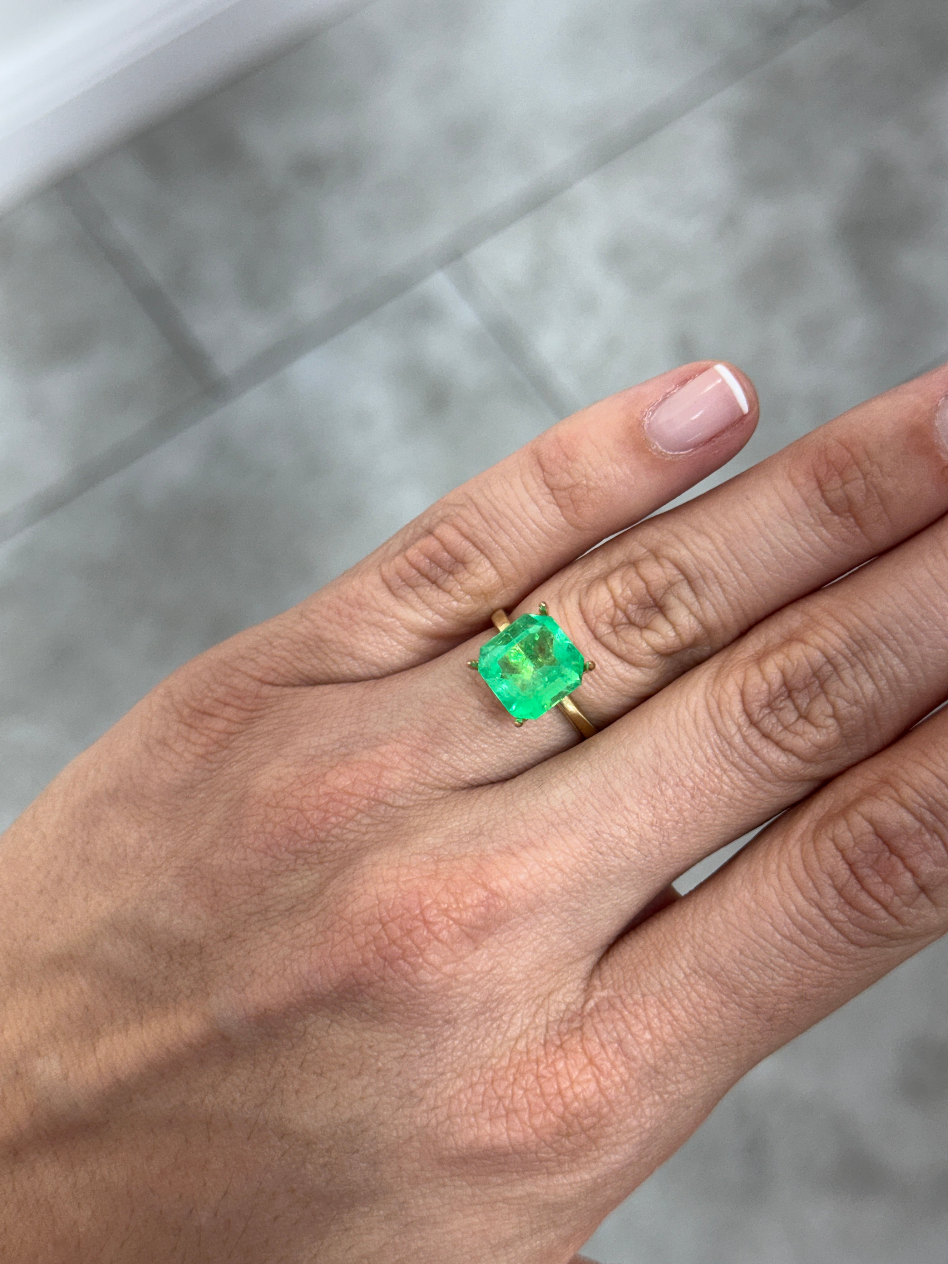 4.57 carat Colombian emerald Asscher cut loose gemstone with clipped corners, glowing green, by JR Colombian Emeralds.