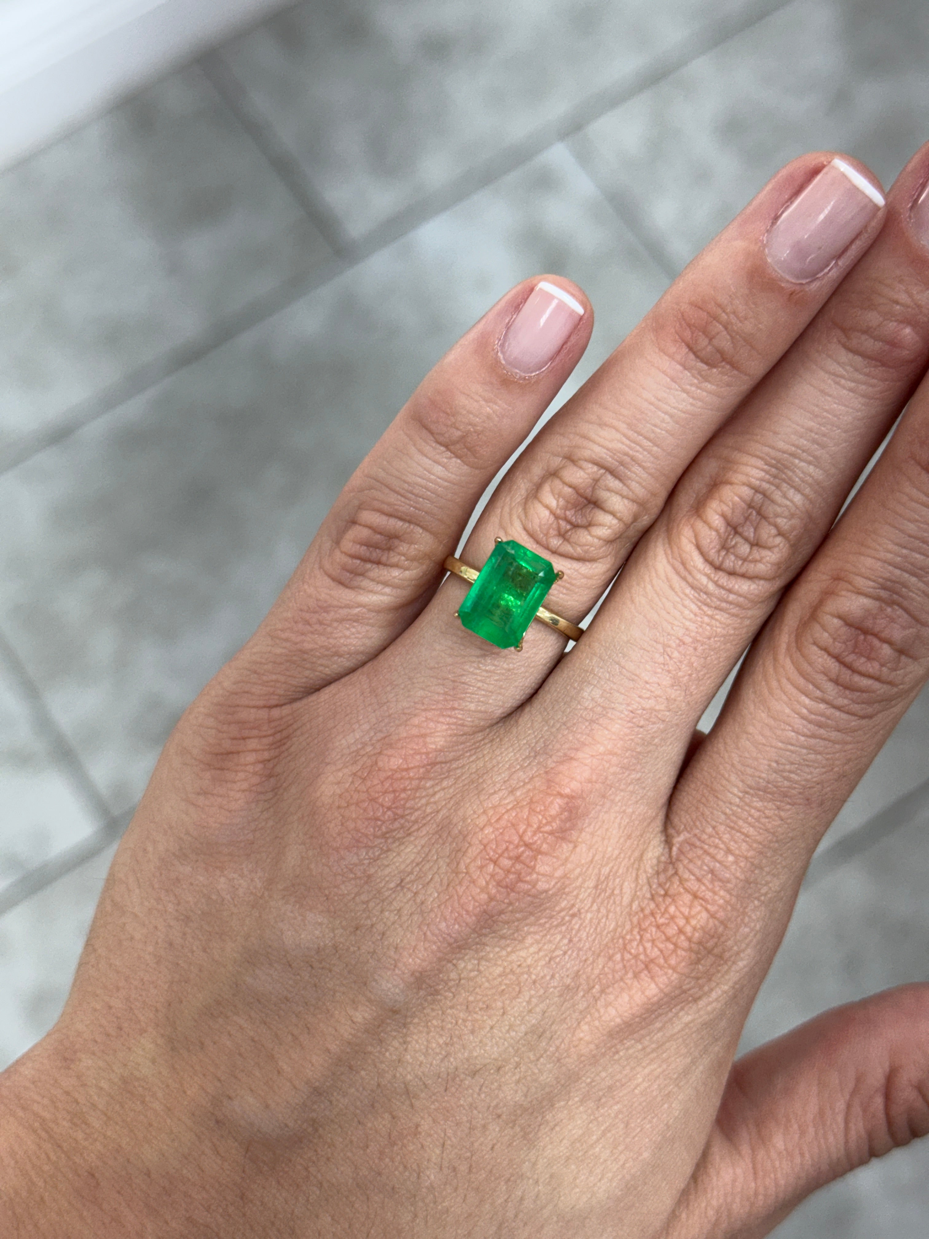Natural 4.68 carat 12x8mm Colombian emerald loose gemstone in emerald cut, showcasing vibrant green color and clarity.