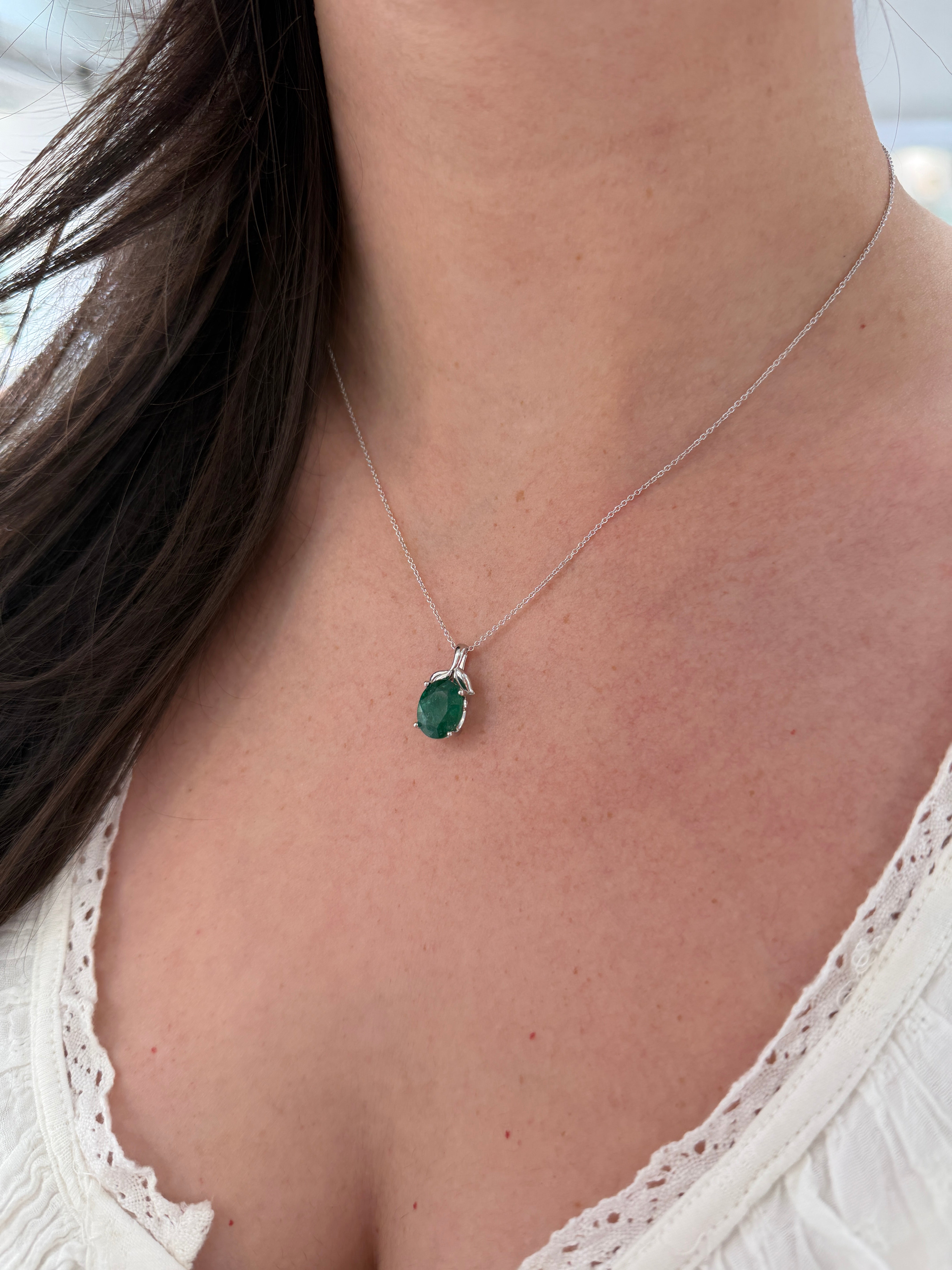 Emerald necklace featuring a 3.23 carat oval cut emerald pendant with leaf bail in platinum, inspired by nature, from JR Colombian Emeralds.