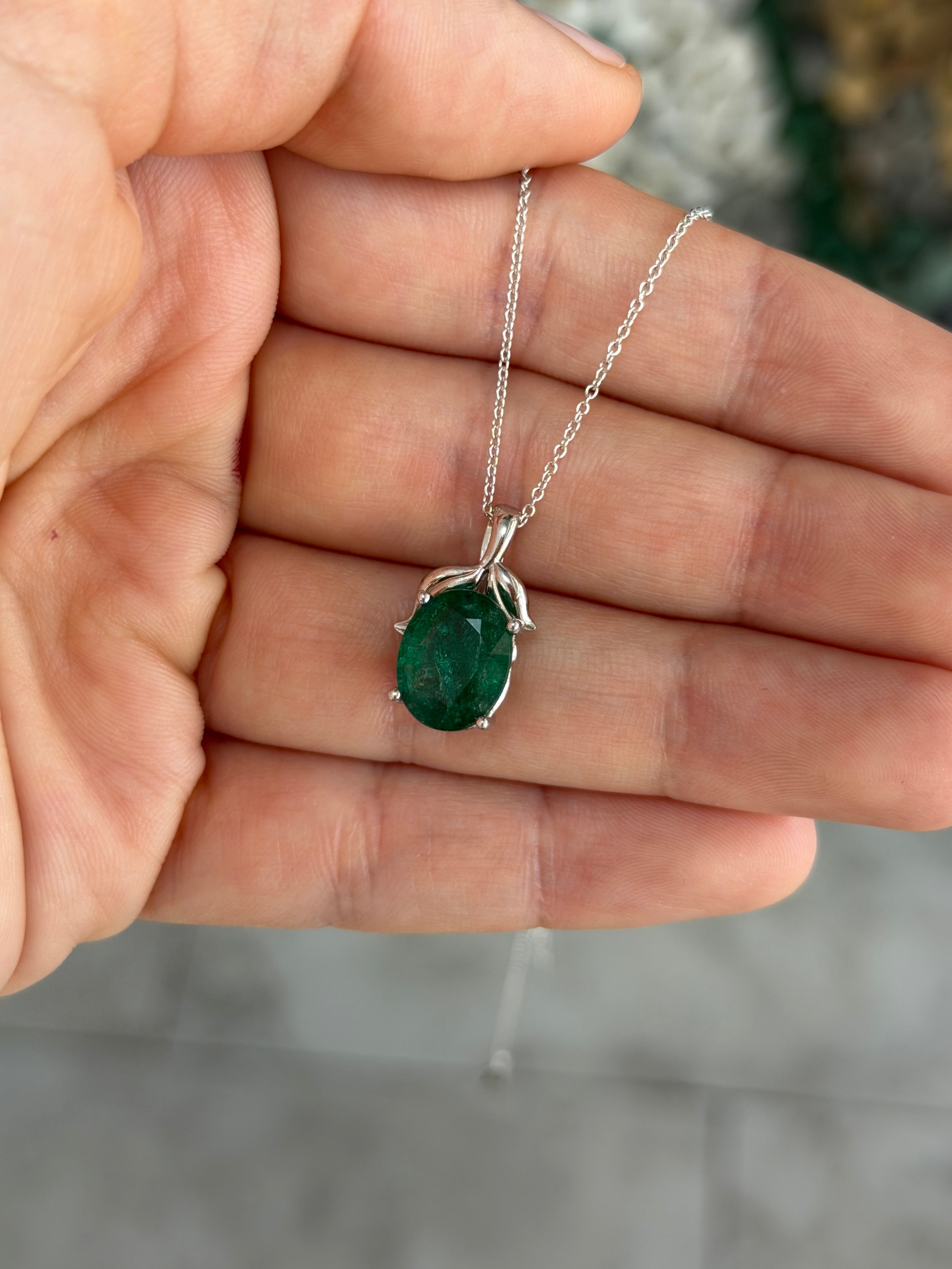 3.23 carat oval cut emerald pendant with leaf design and platinum setting, featuring a nature-inspired emerald necklace by JR Colombian Emeralds.