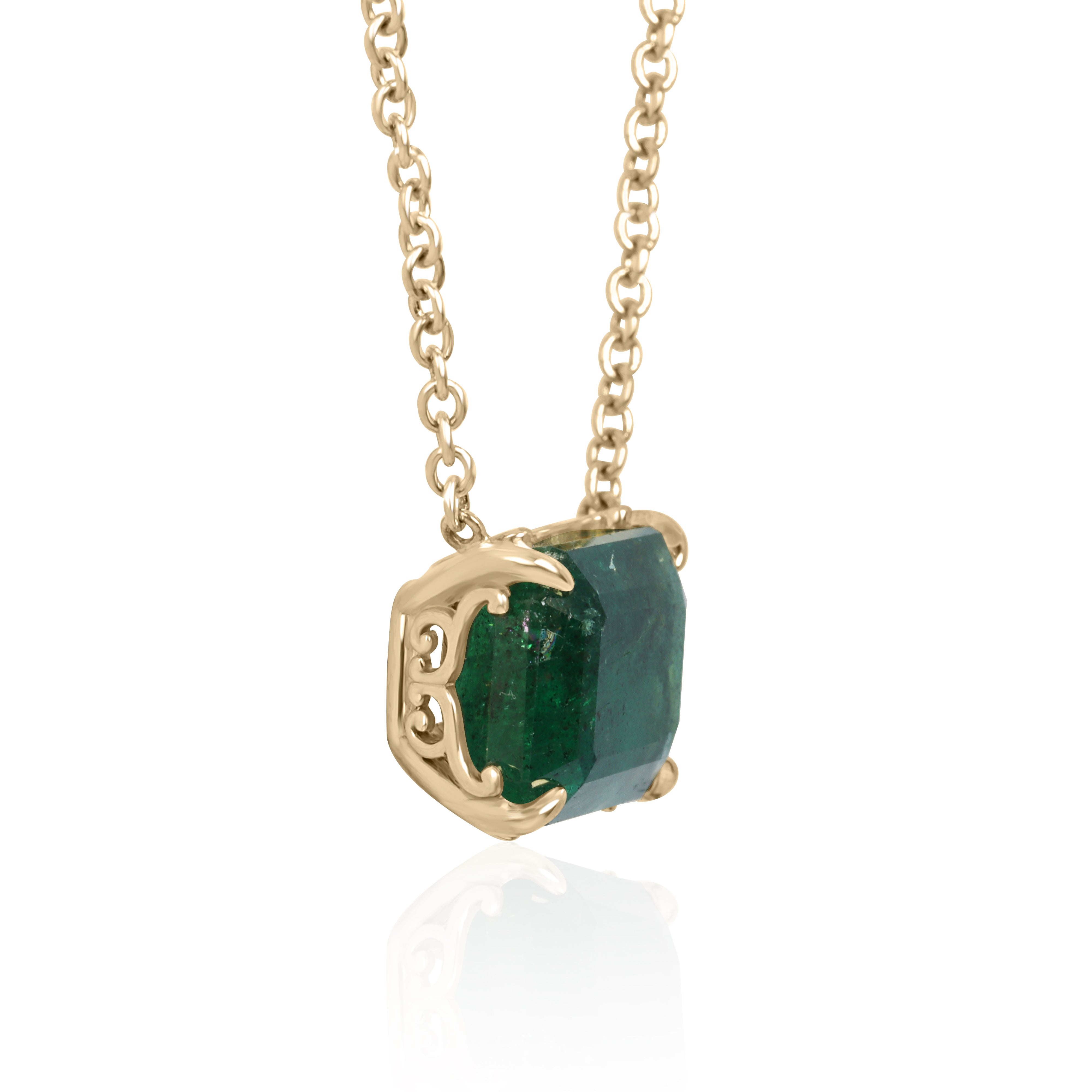18K gold East-West emerald solitaire necklace with flower-inspired fleur de lis design, featuring a 5.70ct natural Colombian emerald from JR Emeralds.