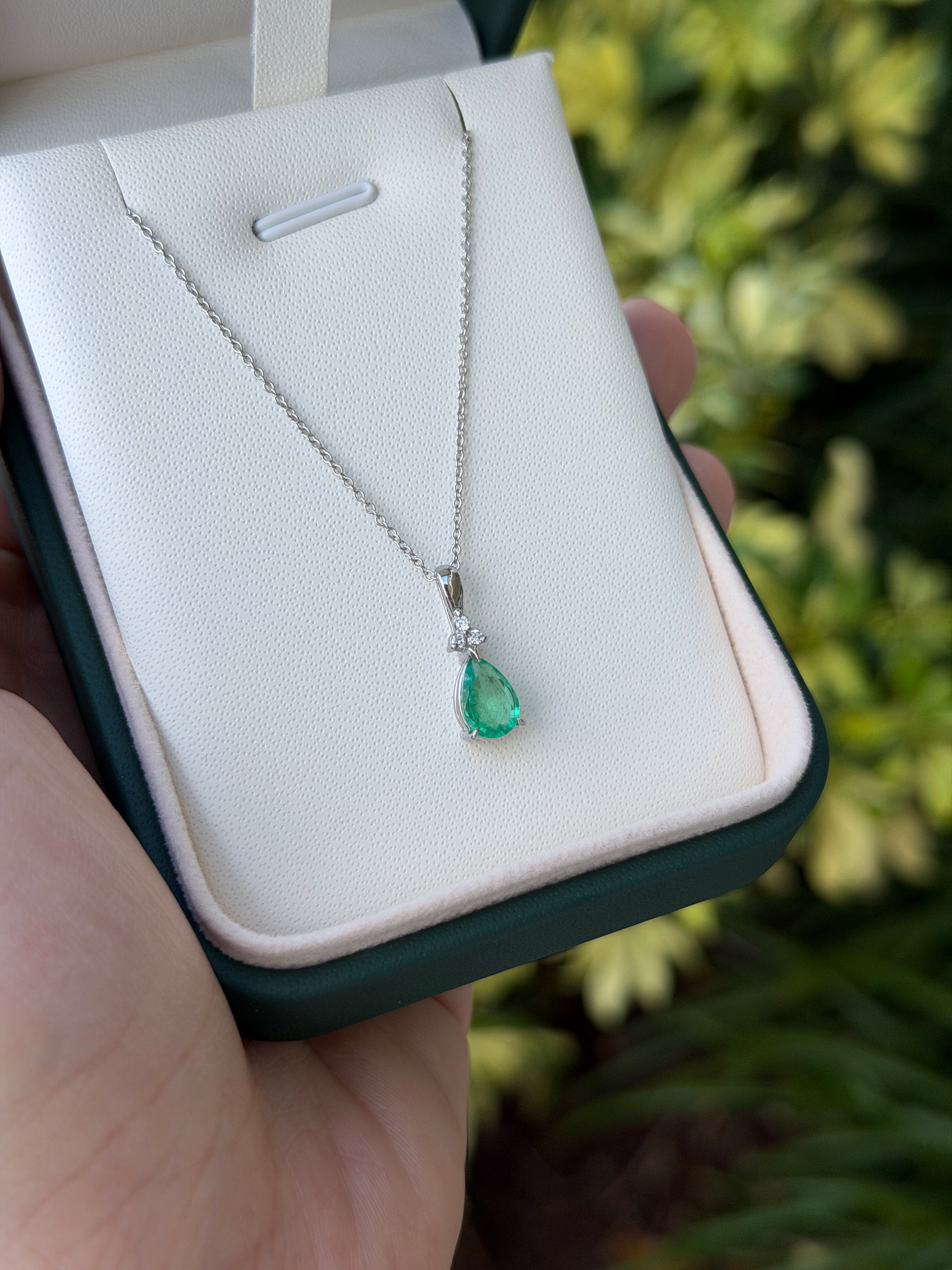 Pear-shaped emerald drop pendant with trefoil diamond cluster in 14K white gold, featuring a 1.04tcw emerald from JR Colombian Emeralds.