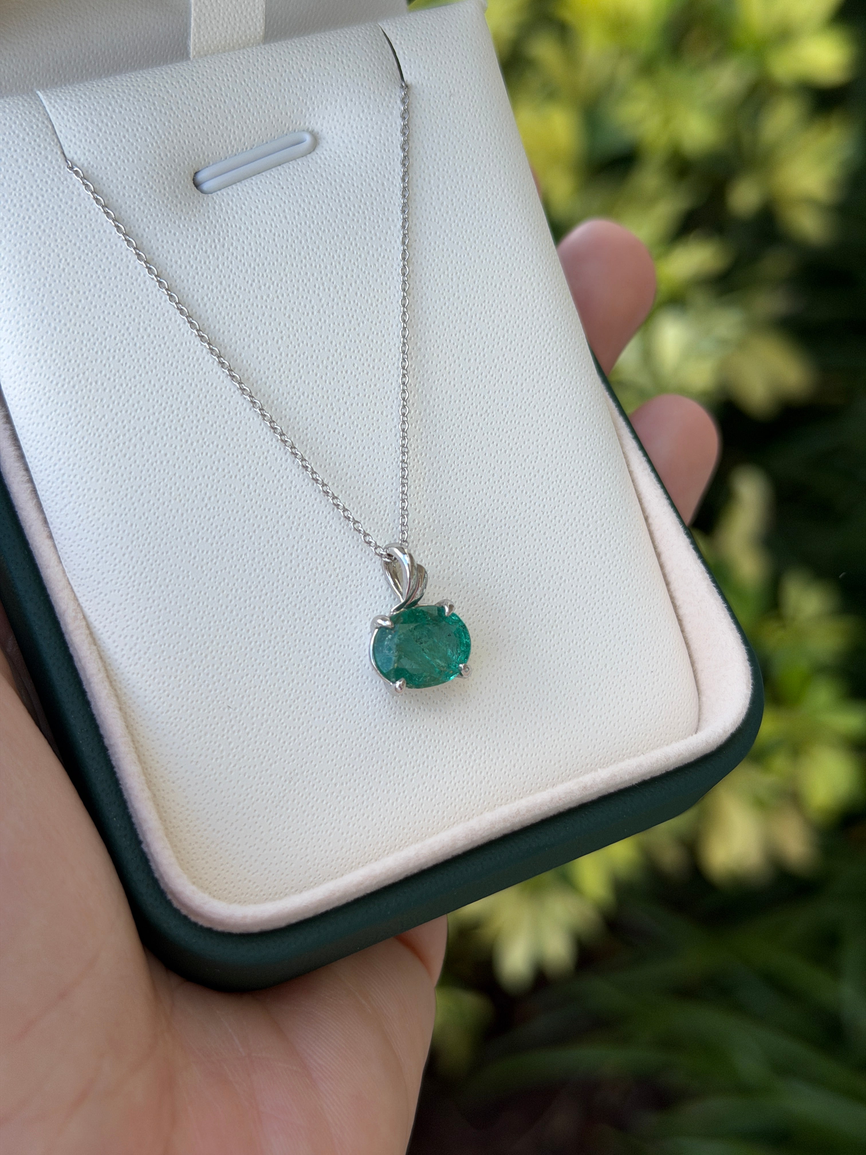 2.60ct oval emerald leaf pendant necklace in 14K white gold, featuring an earthy east-to-west cut emerald from JR Colombian Emeralds