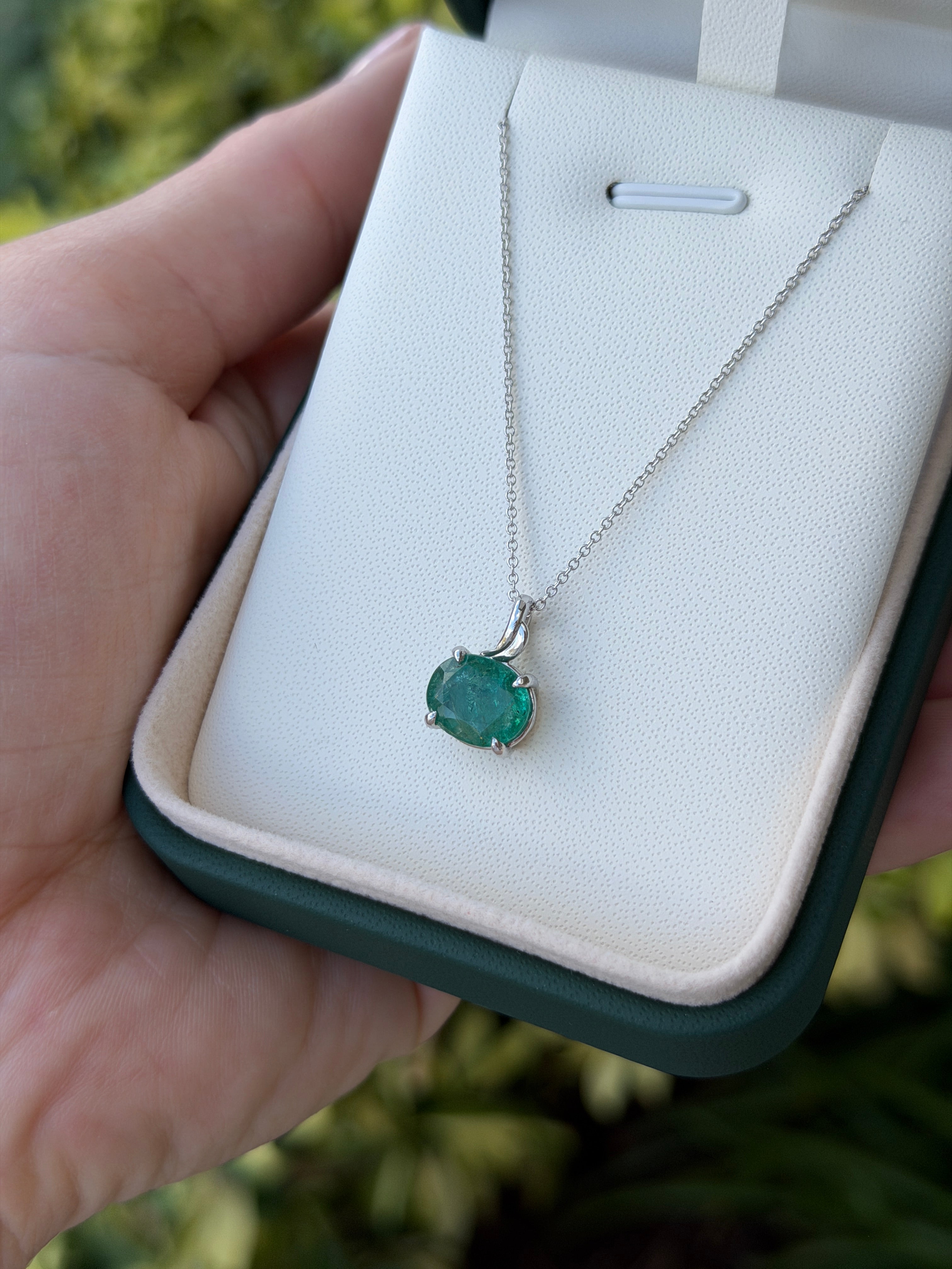 Earthy 2.60ct east-west oval emerald solitaire leaf pendant necklace in 14K white gold by JR Colombian Emeralds.
