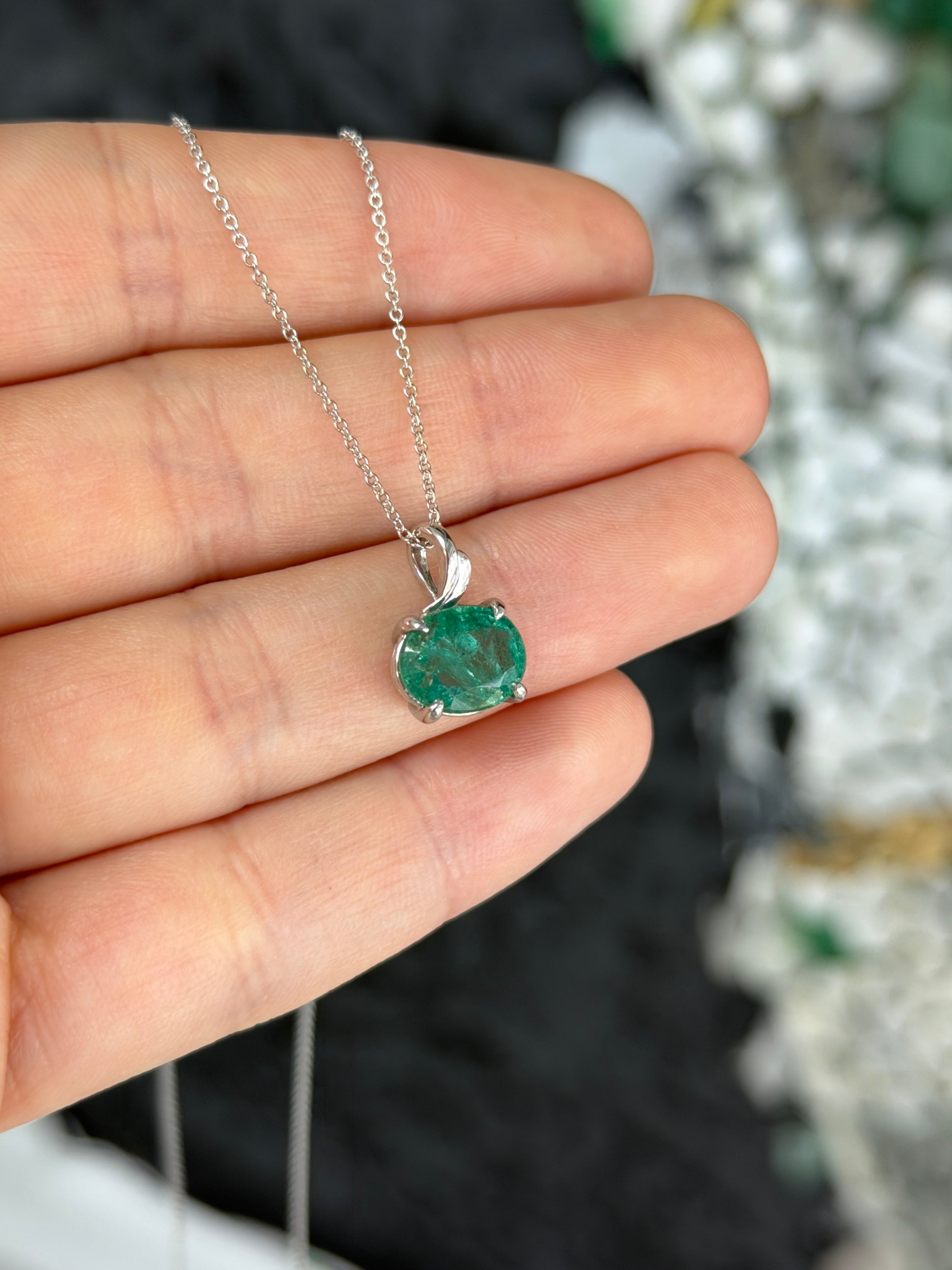 Earthy 2.60ct east-west oval emerald leaf pendant necklace in 14K white gold, featuring natural Colombian emeralds.